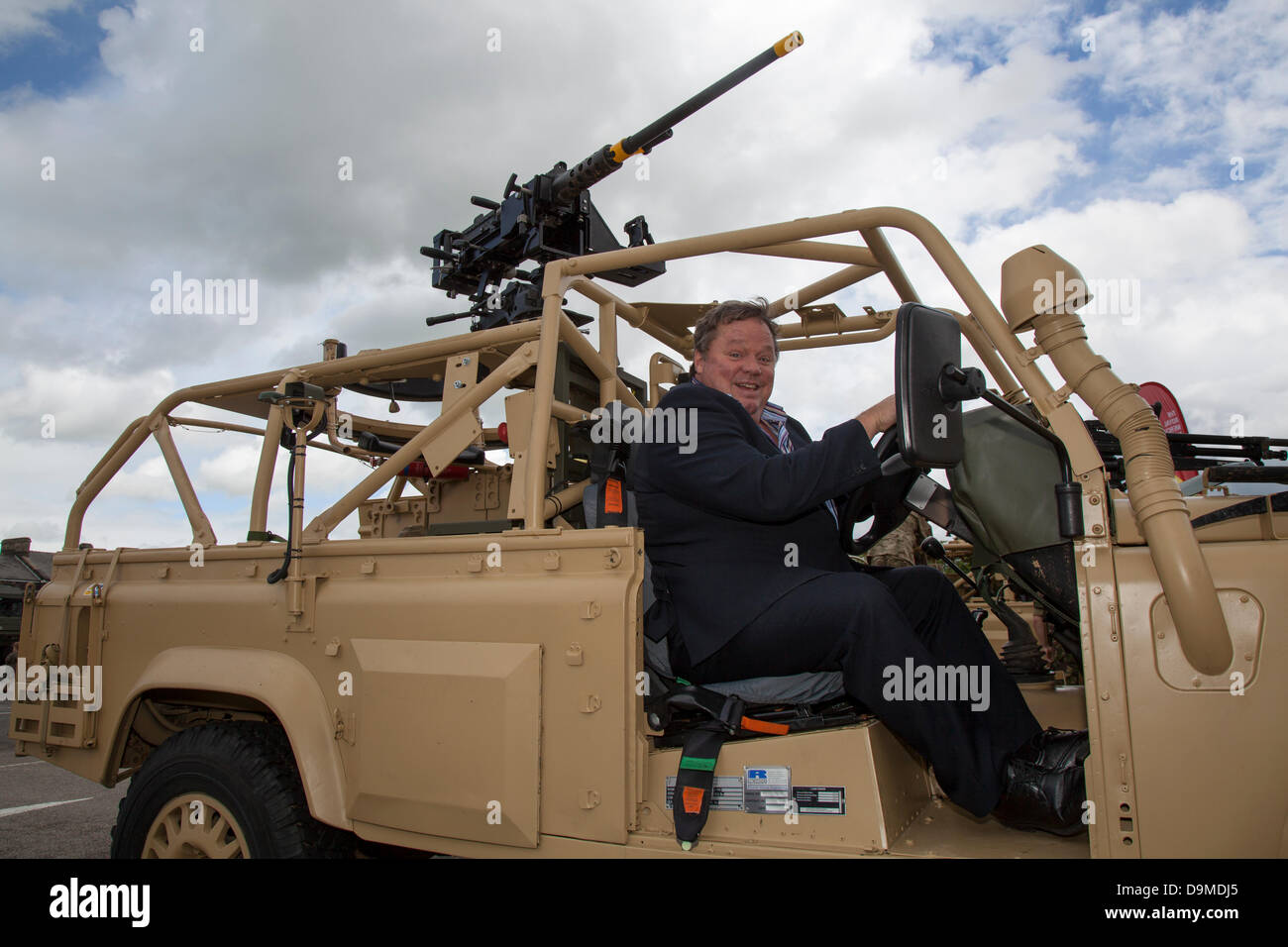 Army Land Rover with snorkel exhaust, at Preston UK, 22 June 2013. Ted Robbins actor, television presenter and radio broadcaster at the Preston Military Show at Fulwood Barracks, Preston, Lancashire .   Servicemen and women, cadets and veterans represent the Royal Navy, the Army and the Royal Air Force from all over the North West: Cheshire, Cumbria, Lancashire, Merseyside and Greater Manchester.  The Preston Military Show is the largest display by the armed forces in the North West of England. Stock Photo