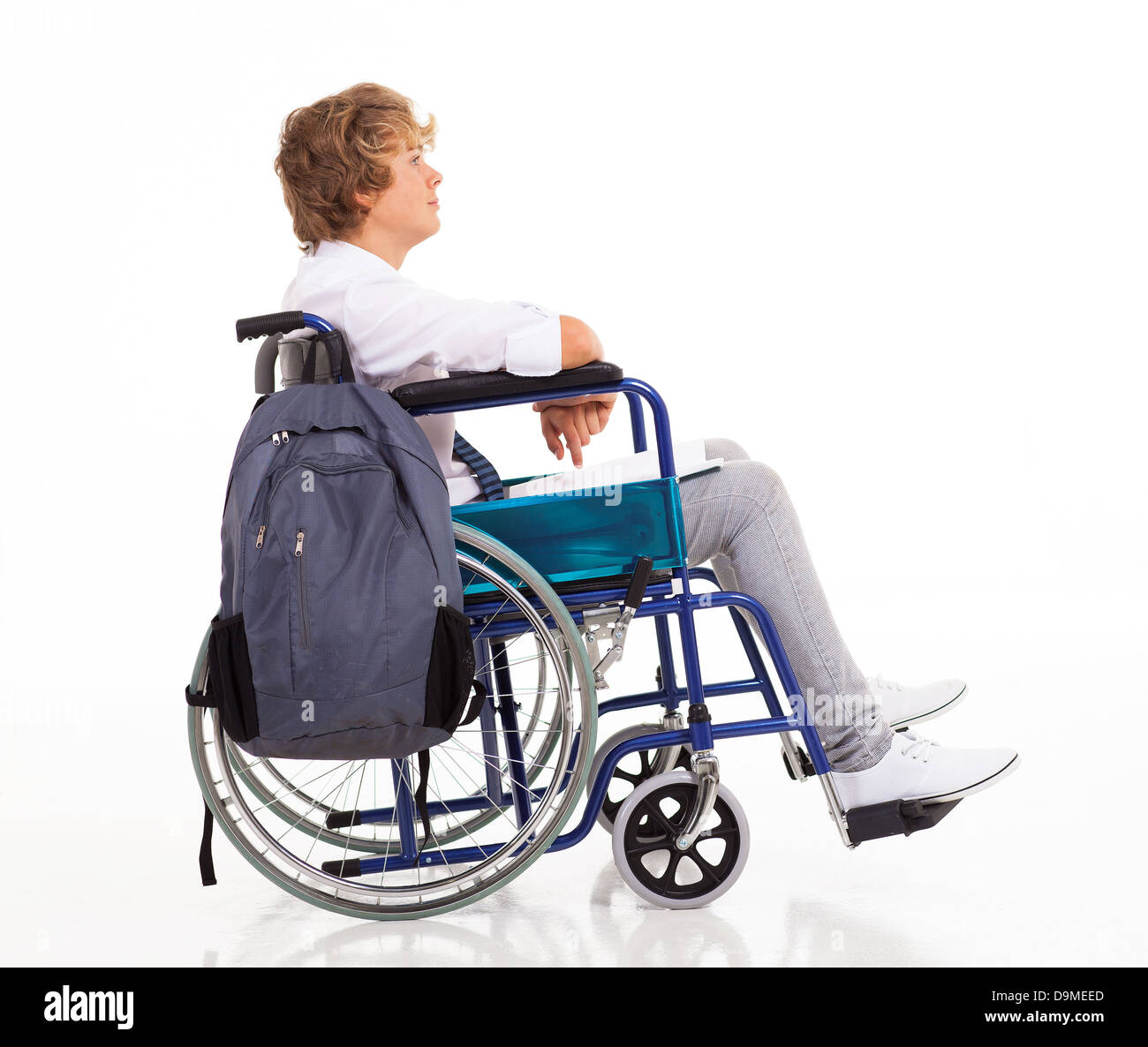 side view of handicapped teen boy sitting on wheelchair Stock Photo