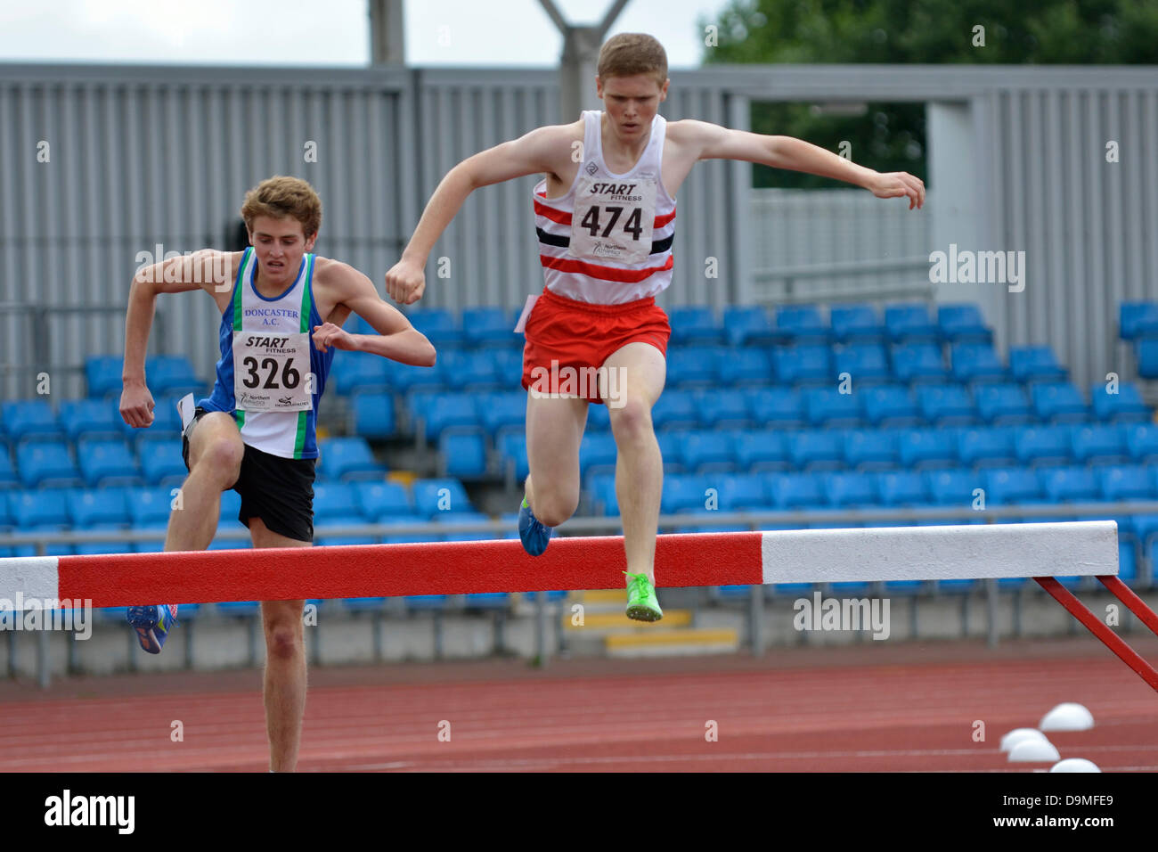 Manchester, UK. 22 June 2013. Northern Athletics Championships  Sportcity  Manchester, UK  22 June 2013 Bertie Houghton (326 Doncaster AC) on his way to winning the U20 2000m Steeplechase in 6.02.64. Haran Dunderdale (474 Lincoln Wellington) comes second in 6.10.38 Credit:  John Fryer/Alamy Live News Stock Photo