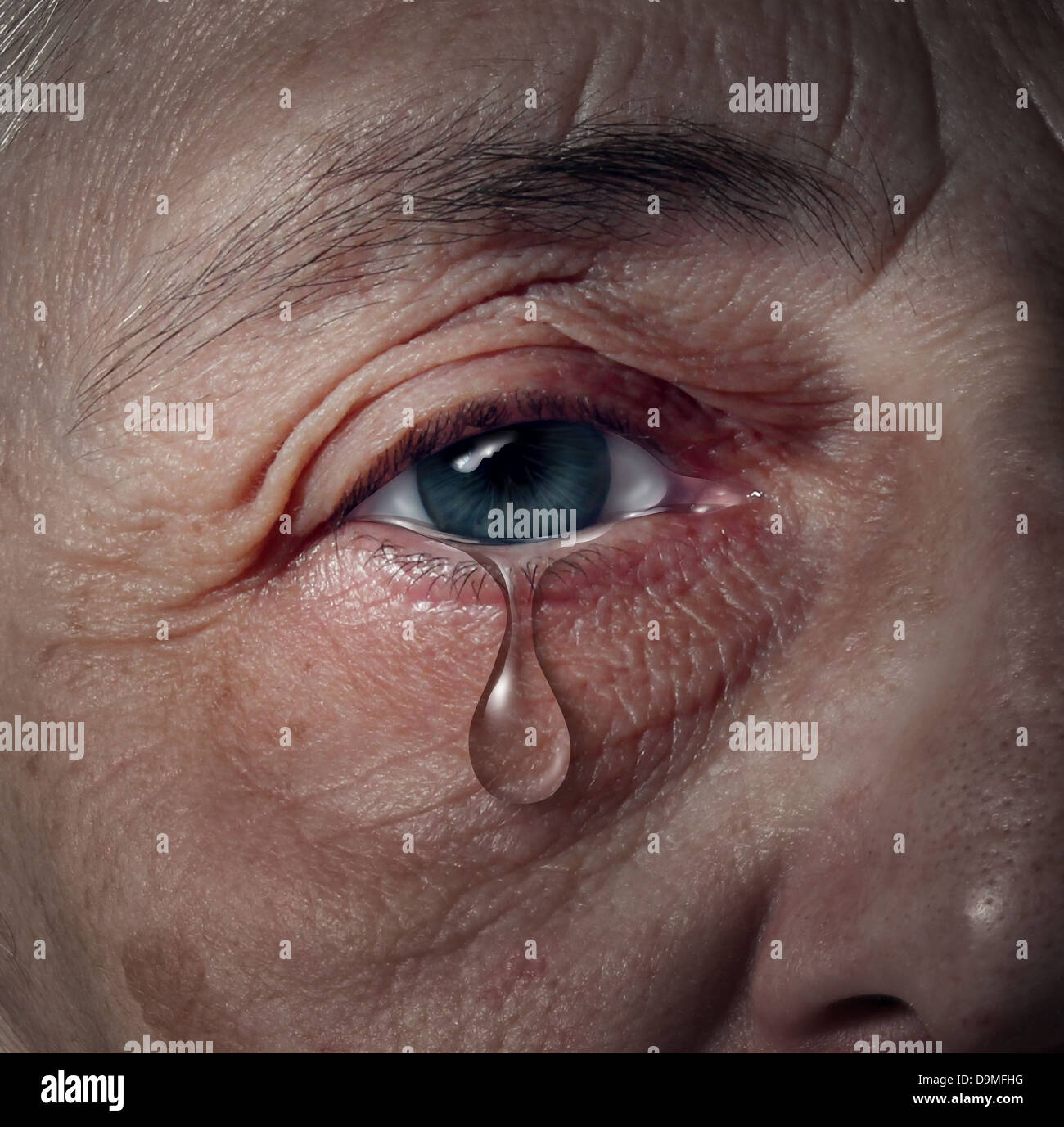 Senior depression and elderly mental health issues related to loneliness and emotional illness based on grief or chemical imbalance causing anxiety as a close up of an aging human eye crying a tear drop. Stock Photo