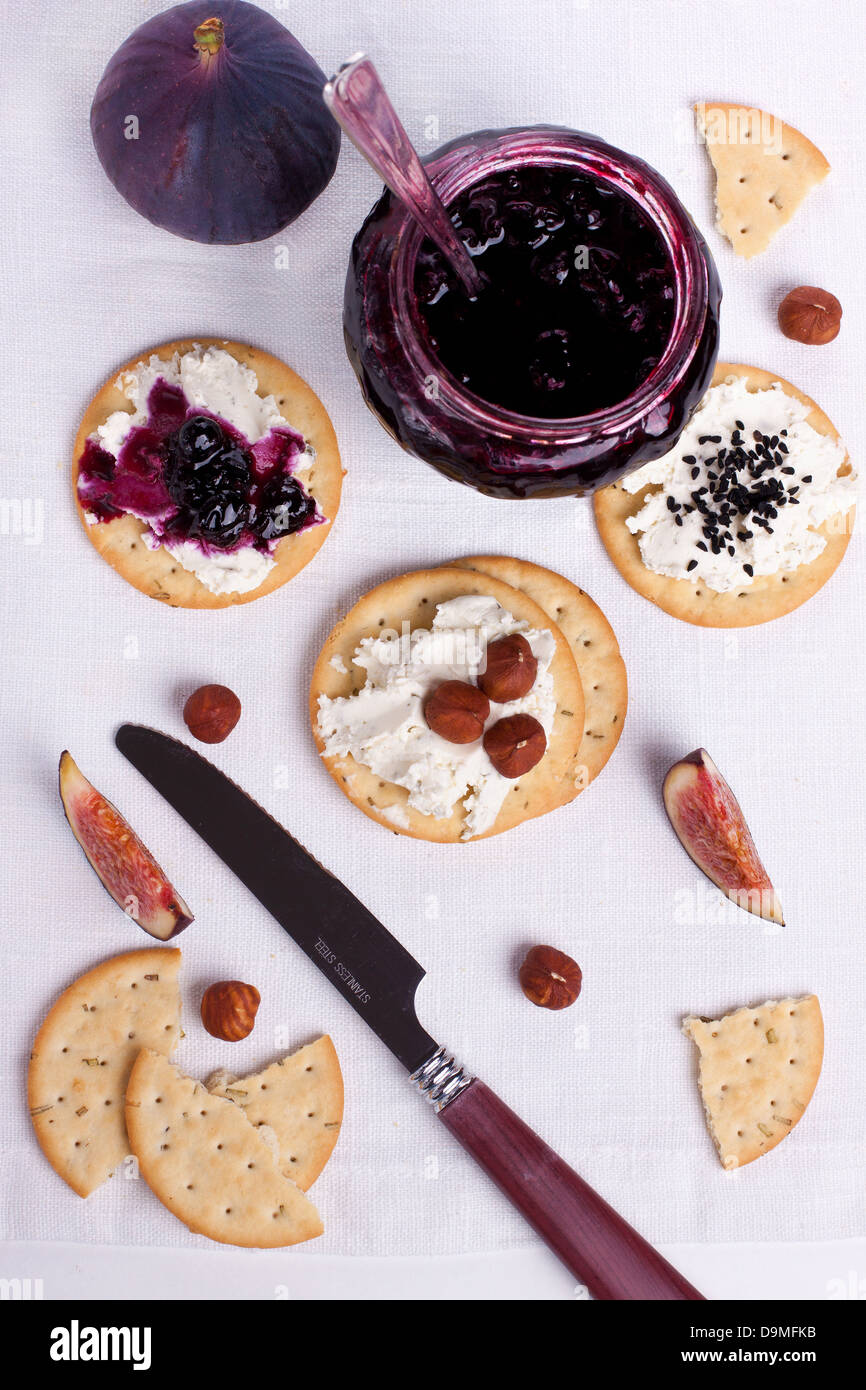 Creamed crackers with jam and nuts Stock Photo Alamy