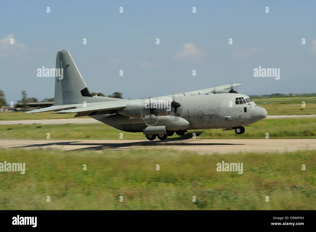 A C-130 Hercules of the Italian Air Force performs a touch and go landing Stock Photo