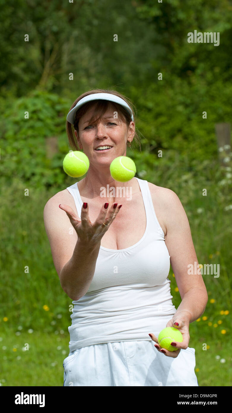 Woman juggling green tennis balls Stock Photo Alamy