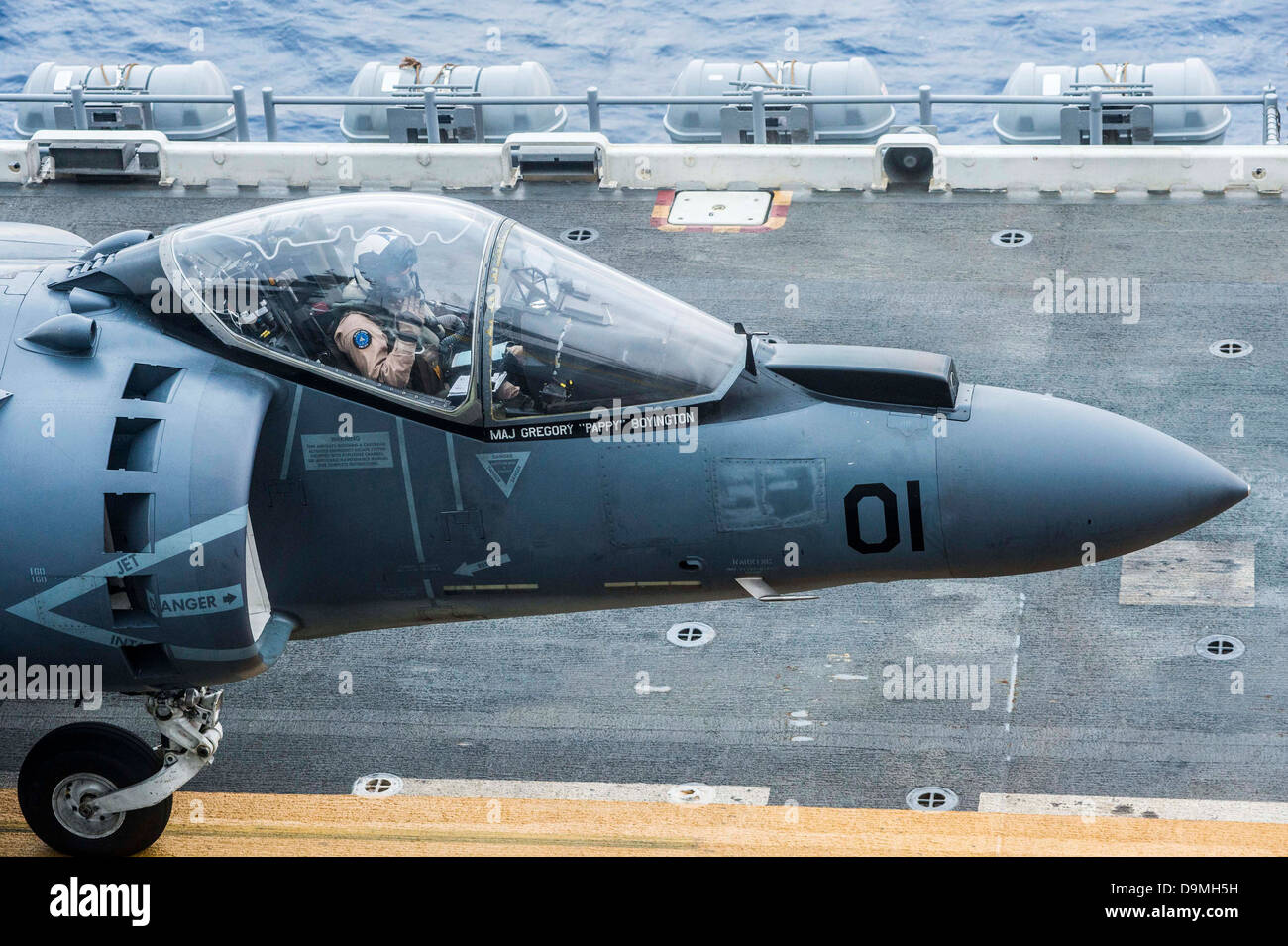 US Marine Corps pilot Maj. Gregory Boyington salutes the landing signalman from his AV-8B Harrier fighter aircraft before taking off from the amphibious assault ship USS Bonhomme Richard June 20, 2013 in the East China Sea. Stock Photo