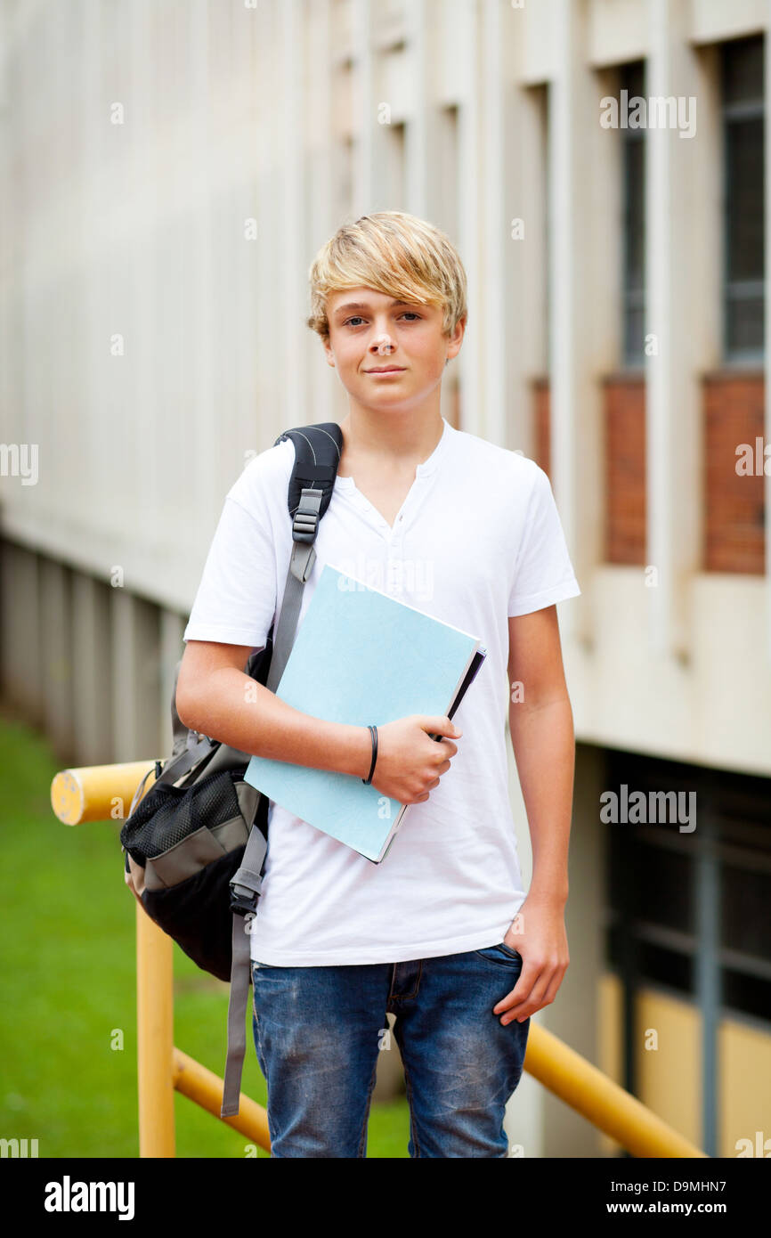 male teen high school student in front of school building Stock Photo