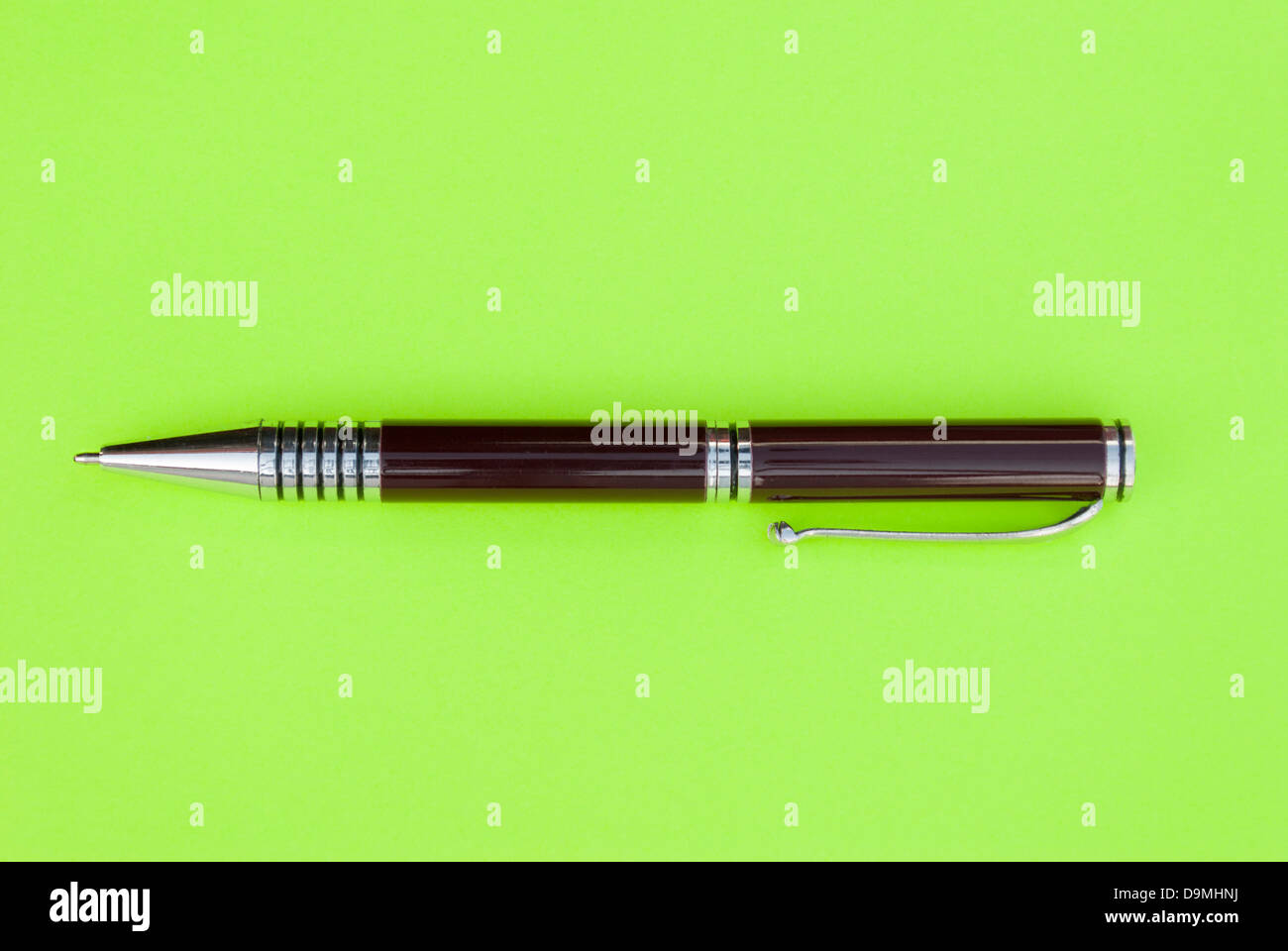 Ballpoint pen on a green sheet of paper Stock Photo