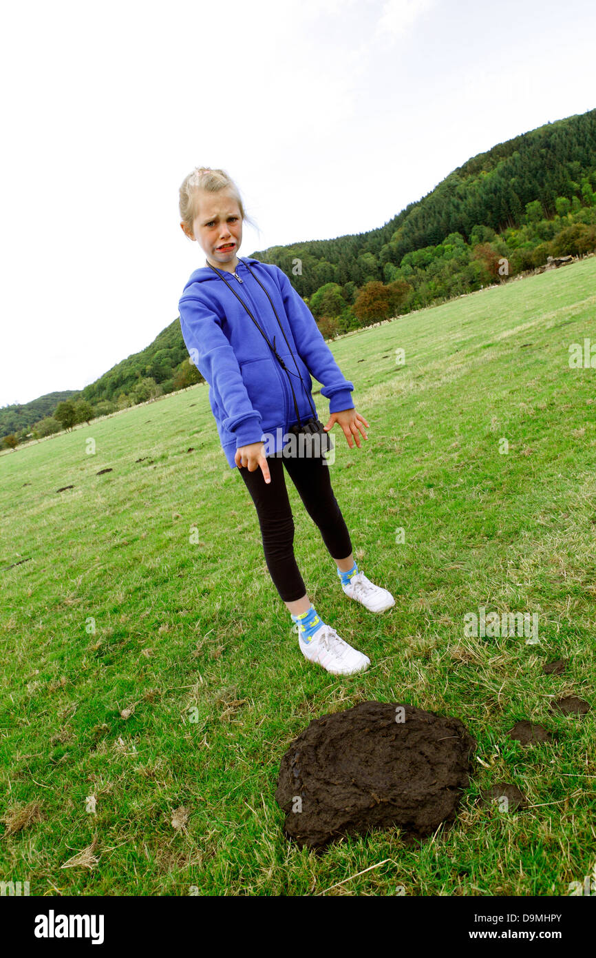 Humour- child finding a cowpat on a country walk. Stock Photo