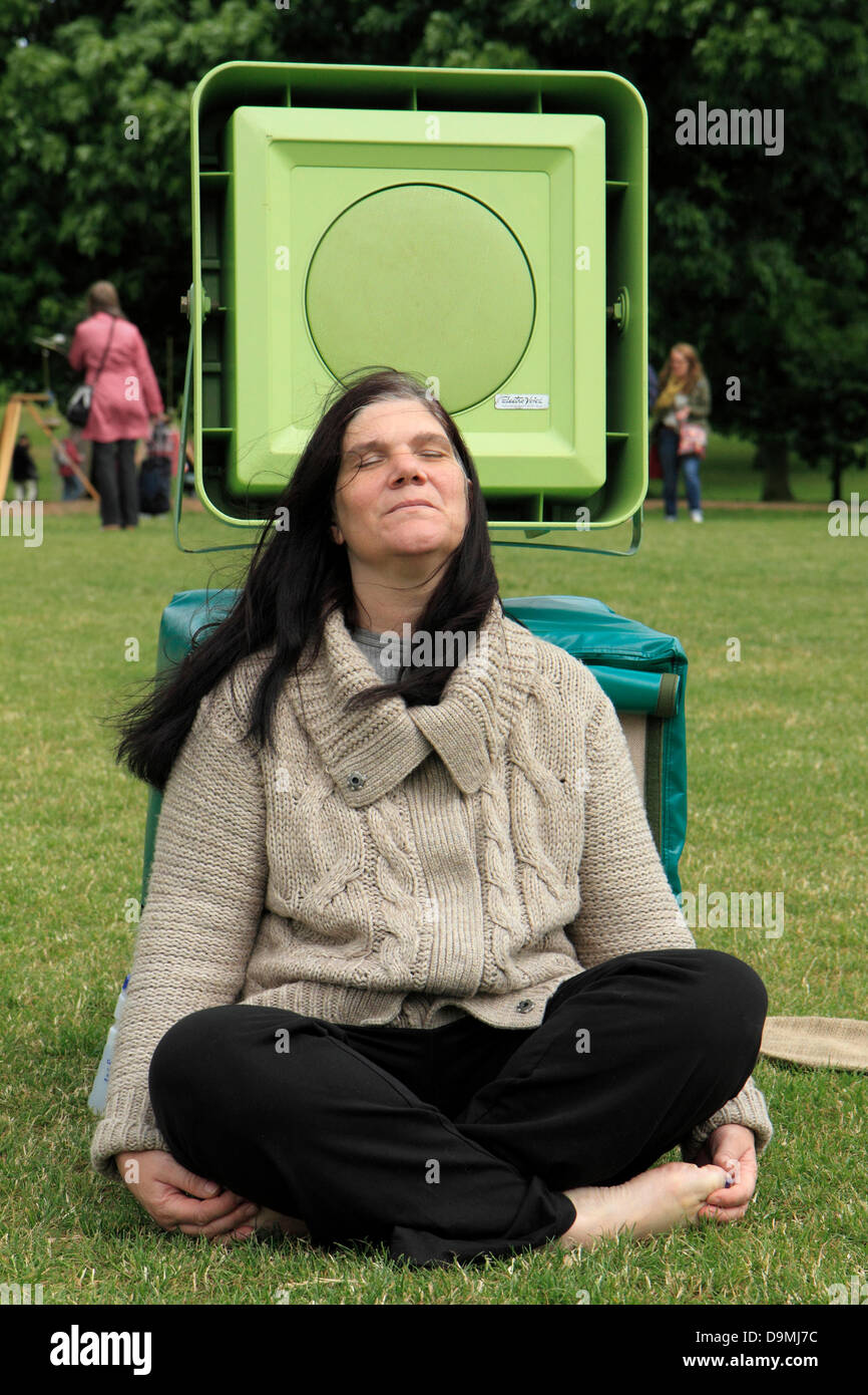 A visitor to the Greenwich Fair 2013 listens to 'Howling Wire' by Dan