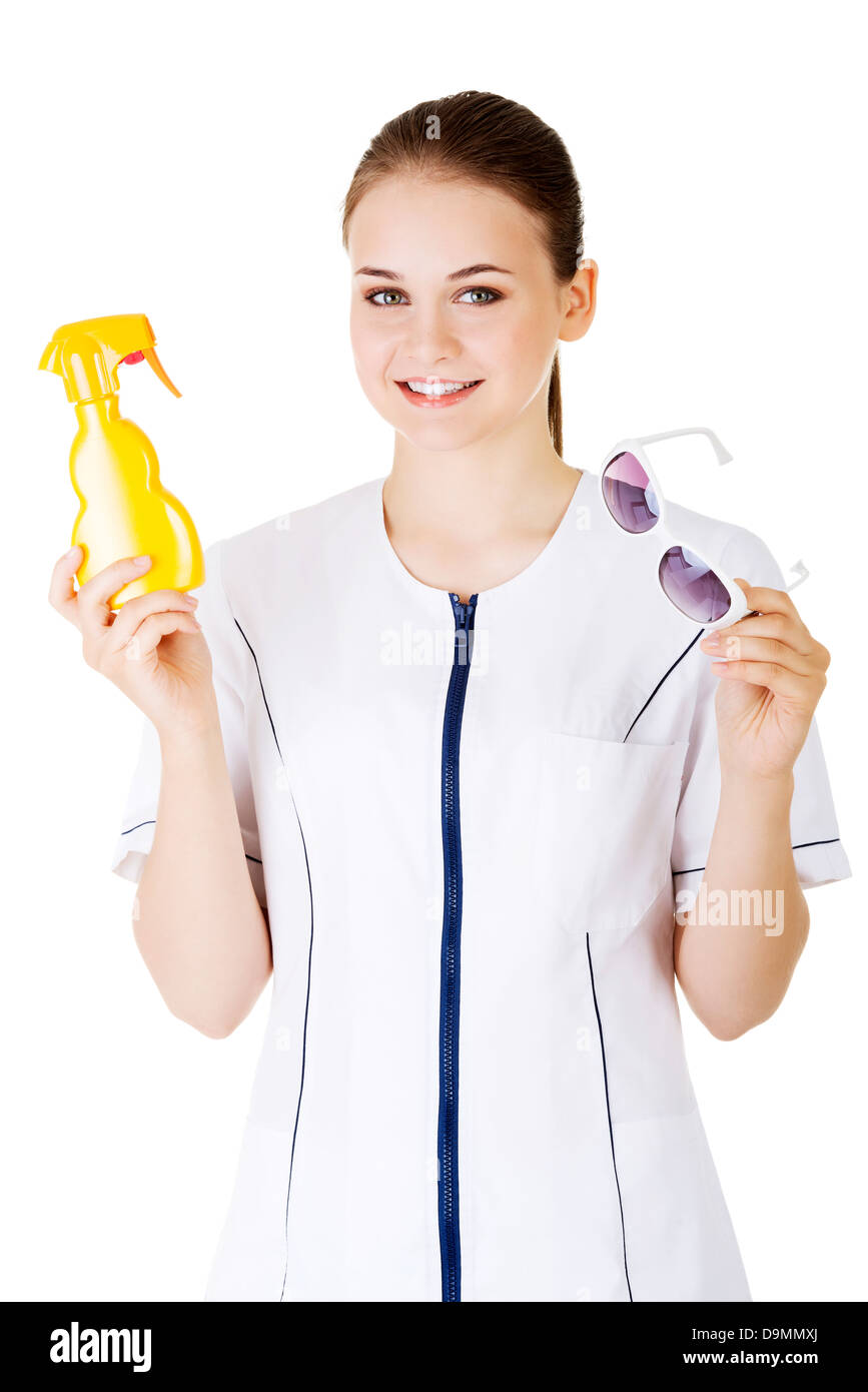 Young female doctor or nurse showing sunscreen and sun glasses fot sun ...