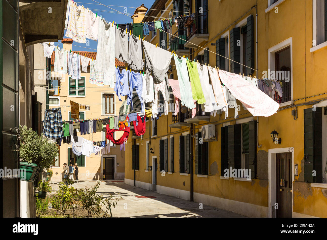 Washing hanging on clothes lines between buildings in Venice Stock Photo