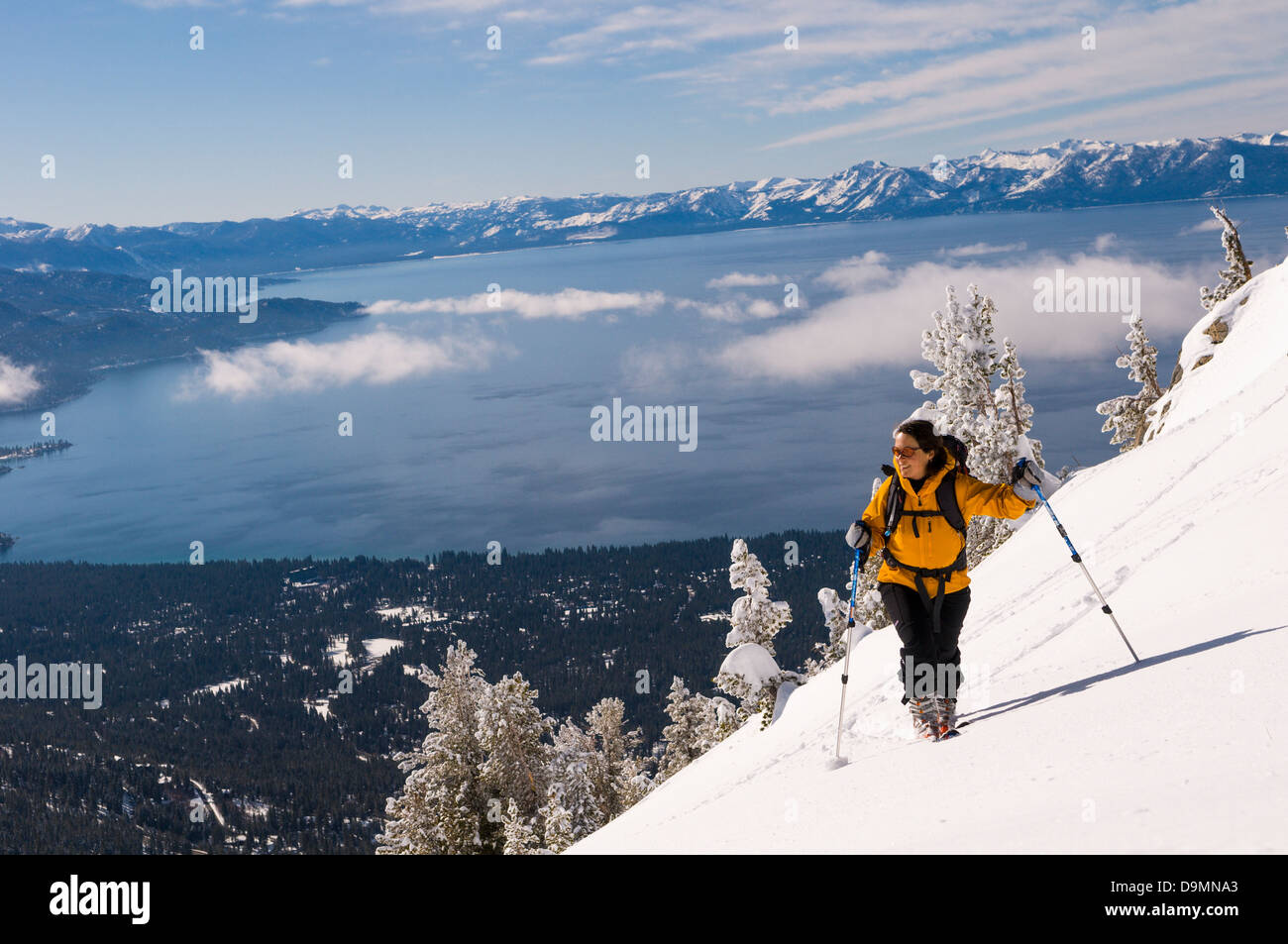 woman backcountry skiing and climbing on Incline Peak with spectacular Lake Tahoe Views Stock Photo
