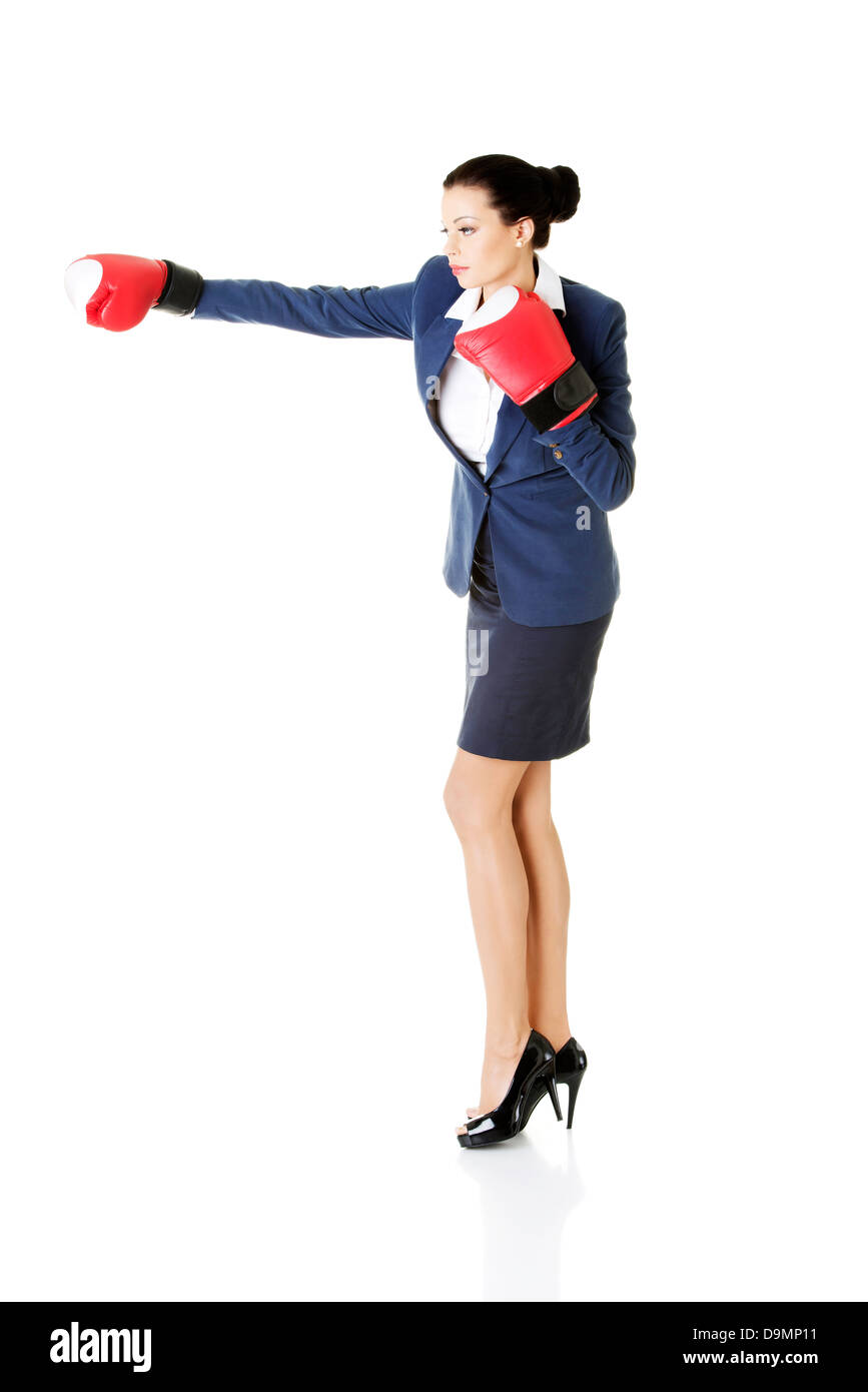 Young businesswoman with boxing gloves, isolated on white background  Stock Photo