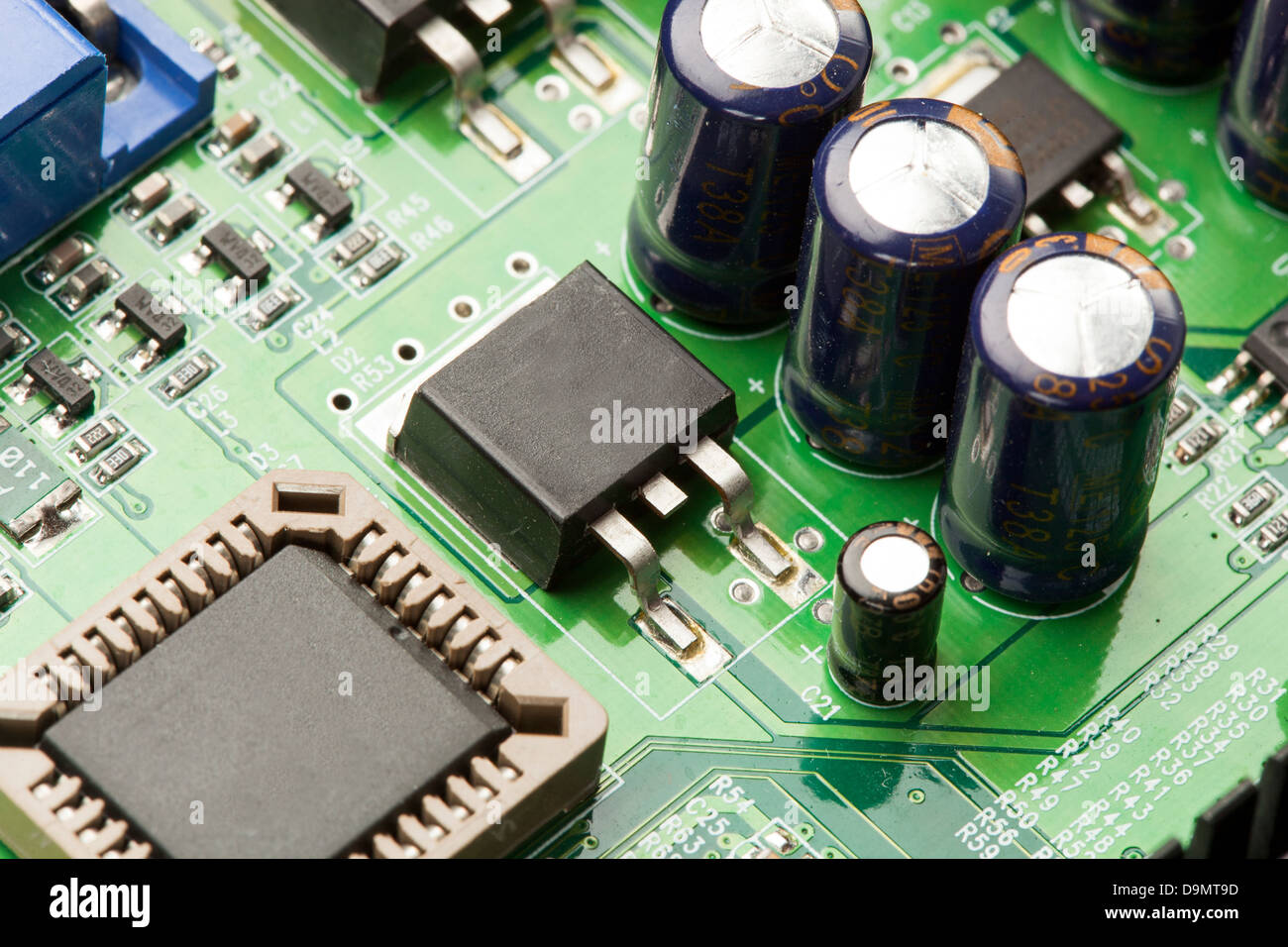 Green Electrical Circuit Board with microchips, conductors, and transistors Stock Photo