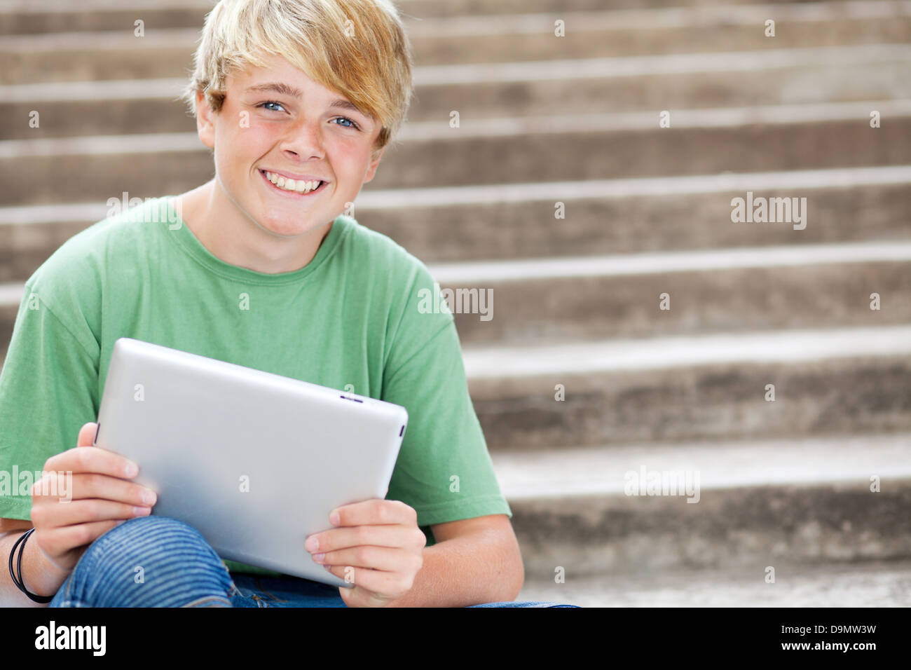 young teen boy using tablet computer Stock Photo