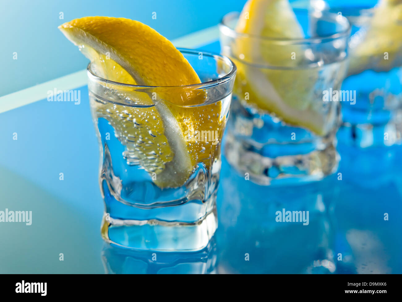 alcohol drink with lemon on a glass table Stock Photo Alamy