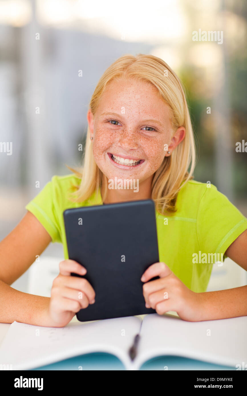 happy teen girl holding tablet computer at home Stock Photo