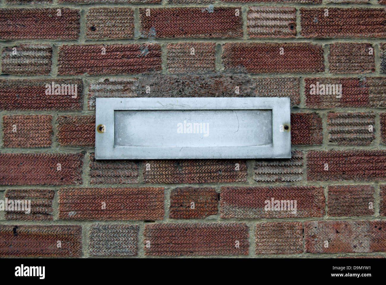 Letter box in brick wall