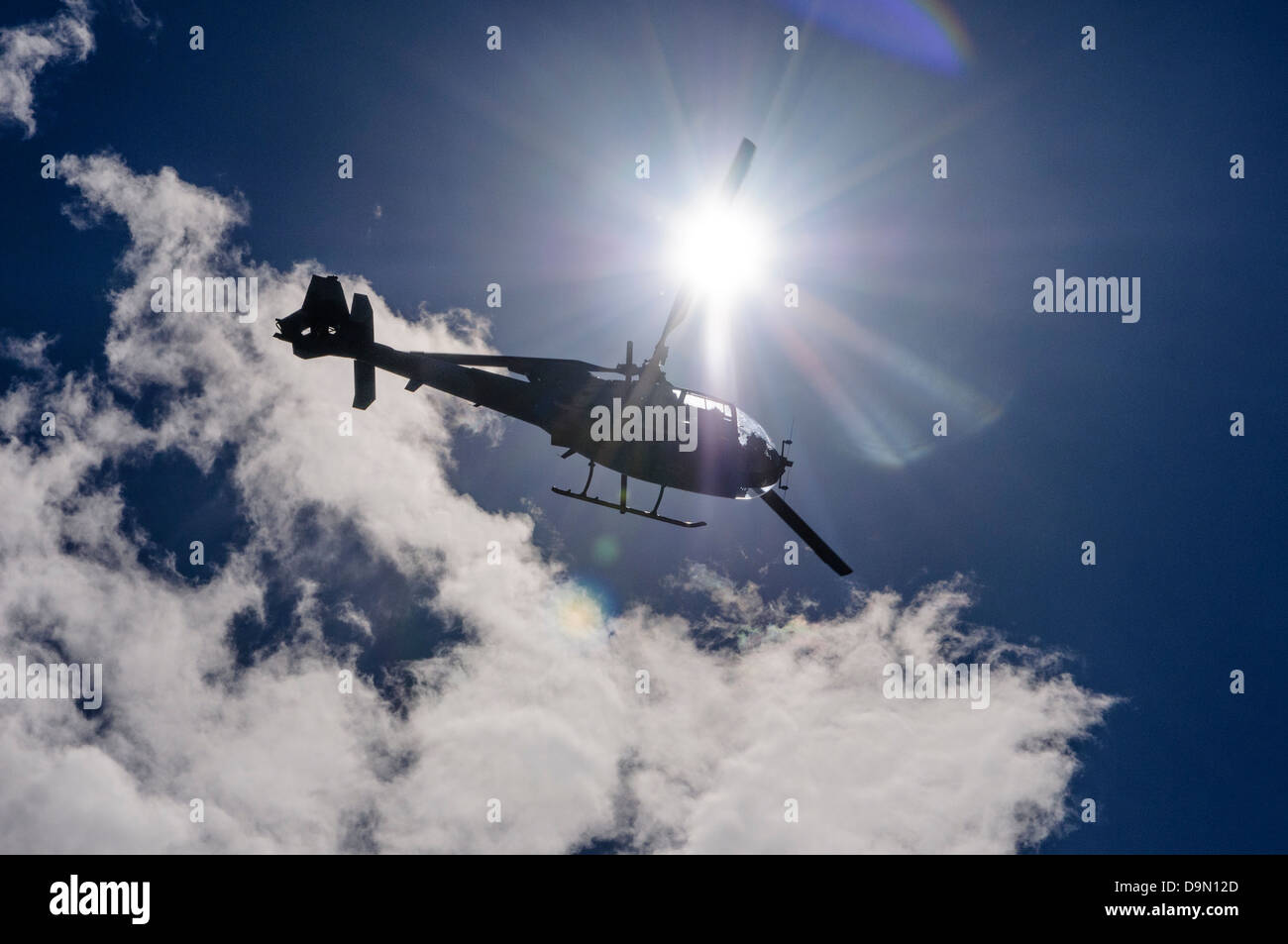 Aérospatiale Gazelle helicopter silhouetted against the sun, commonly used for light transport, scouting and light attack duties Stock Photo