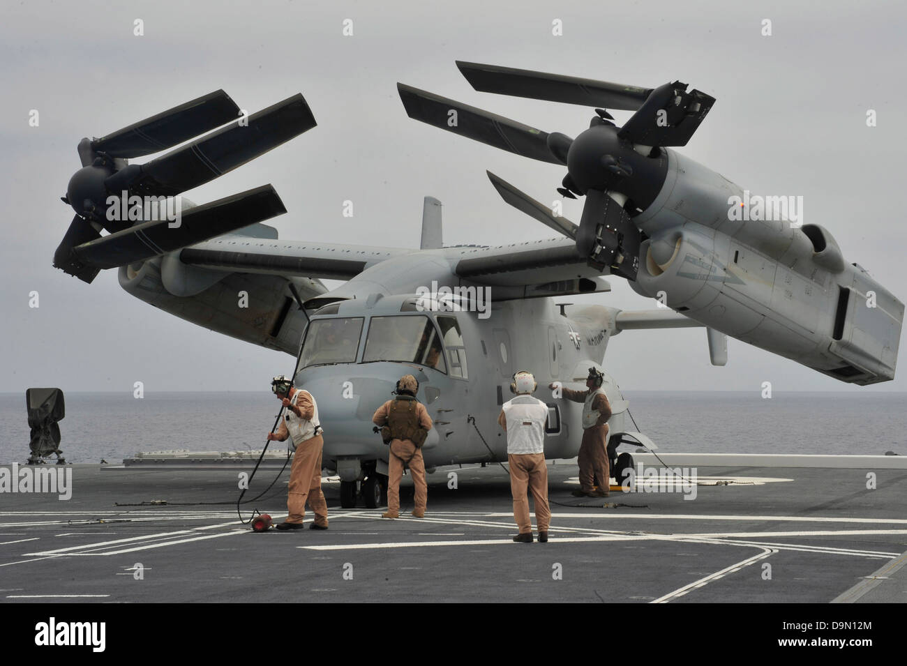 A US Marine Corps MV-22B Osprey aircraft is inspected after landing on ...