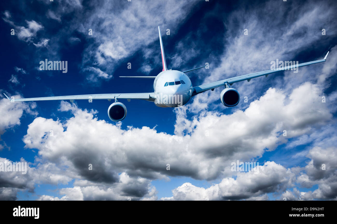Passenger Airliner flying in the clouds Stock Photo - Alamy