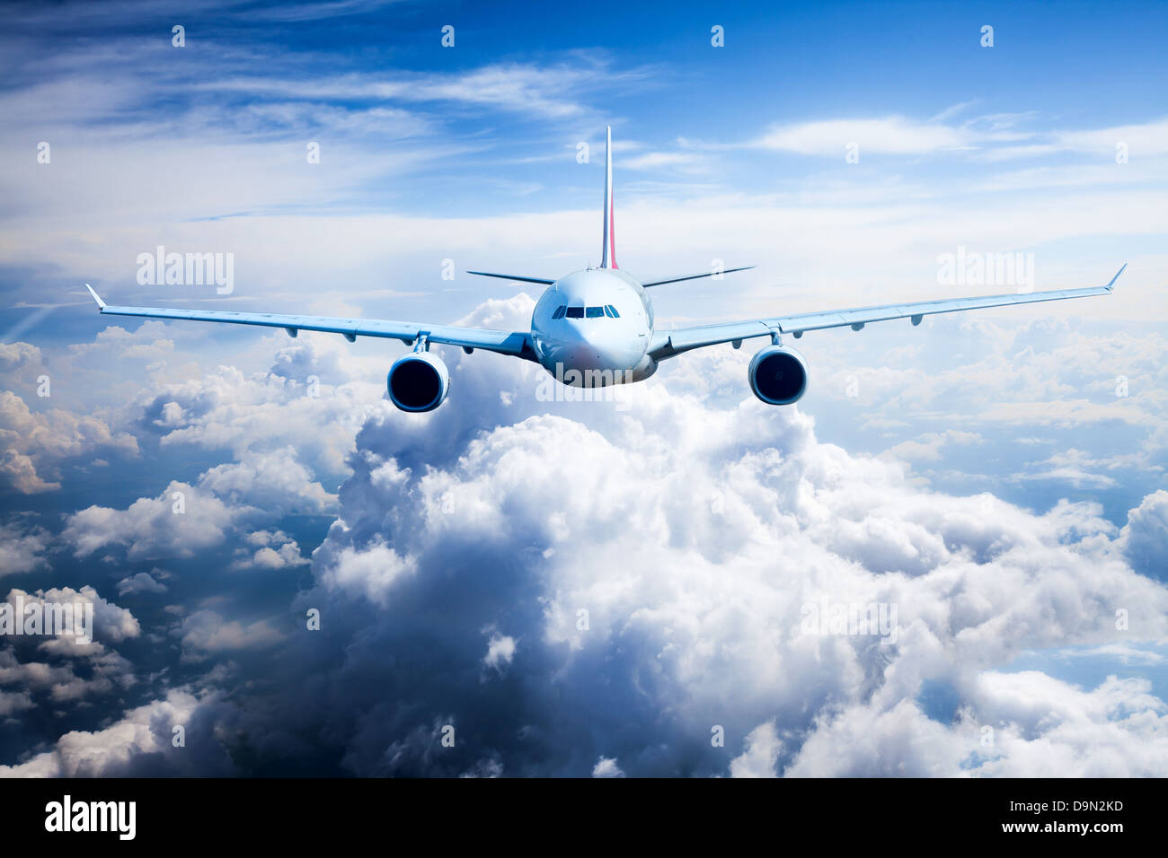 Passenger Airliner flying in the clouds Stock Photo - Alamy