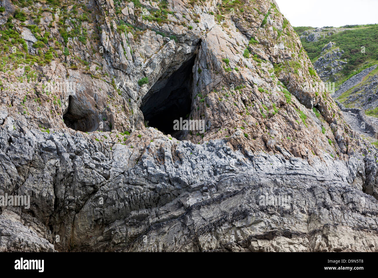 Entrance to Paviland Cave from the sea, Gower, Wales where the Red Lady was found 33000 years ago Stock Photo