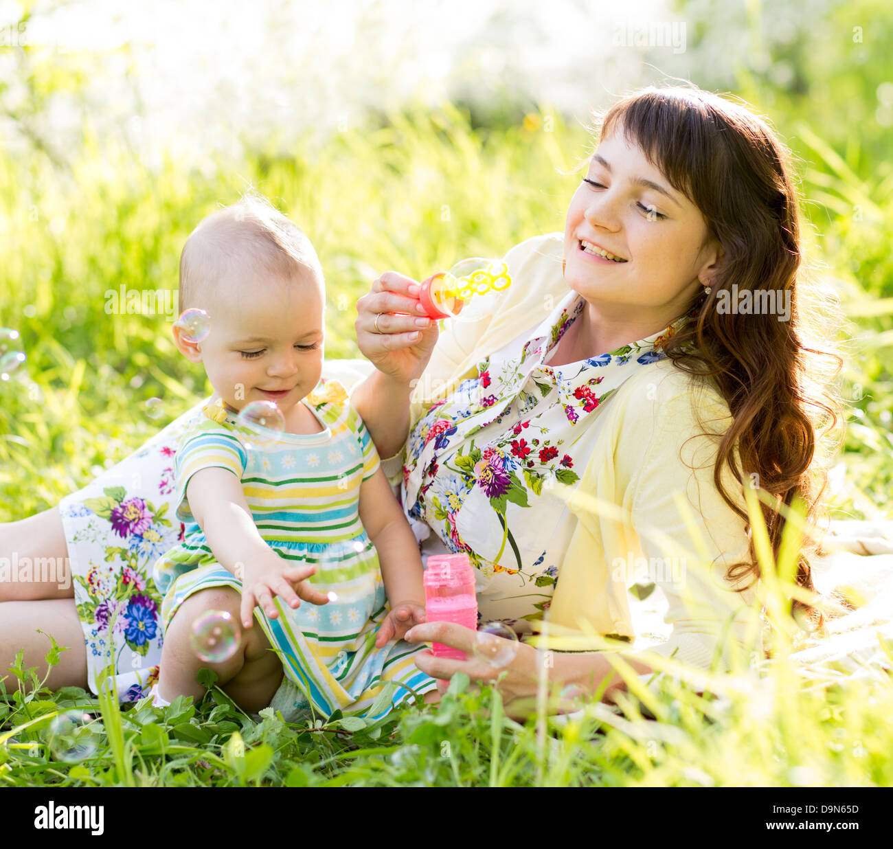 mother and baby girl having fun outdoors Stock Photo