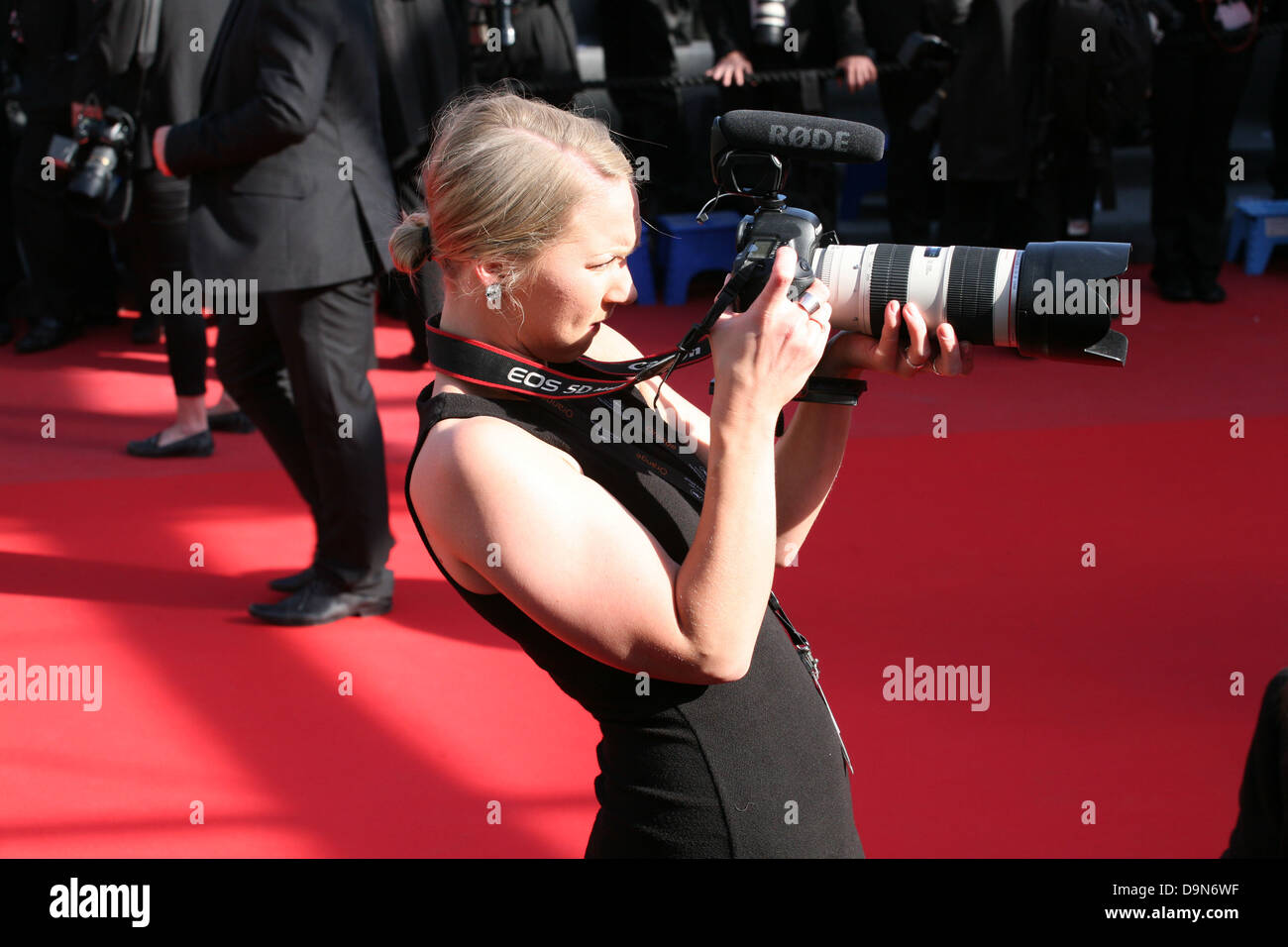 A photographer on the red carpet, Palais des festivals during the 66th Cannes Film Festival 2013 Stock Photo