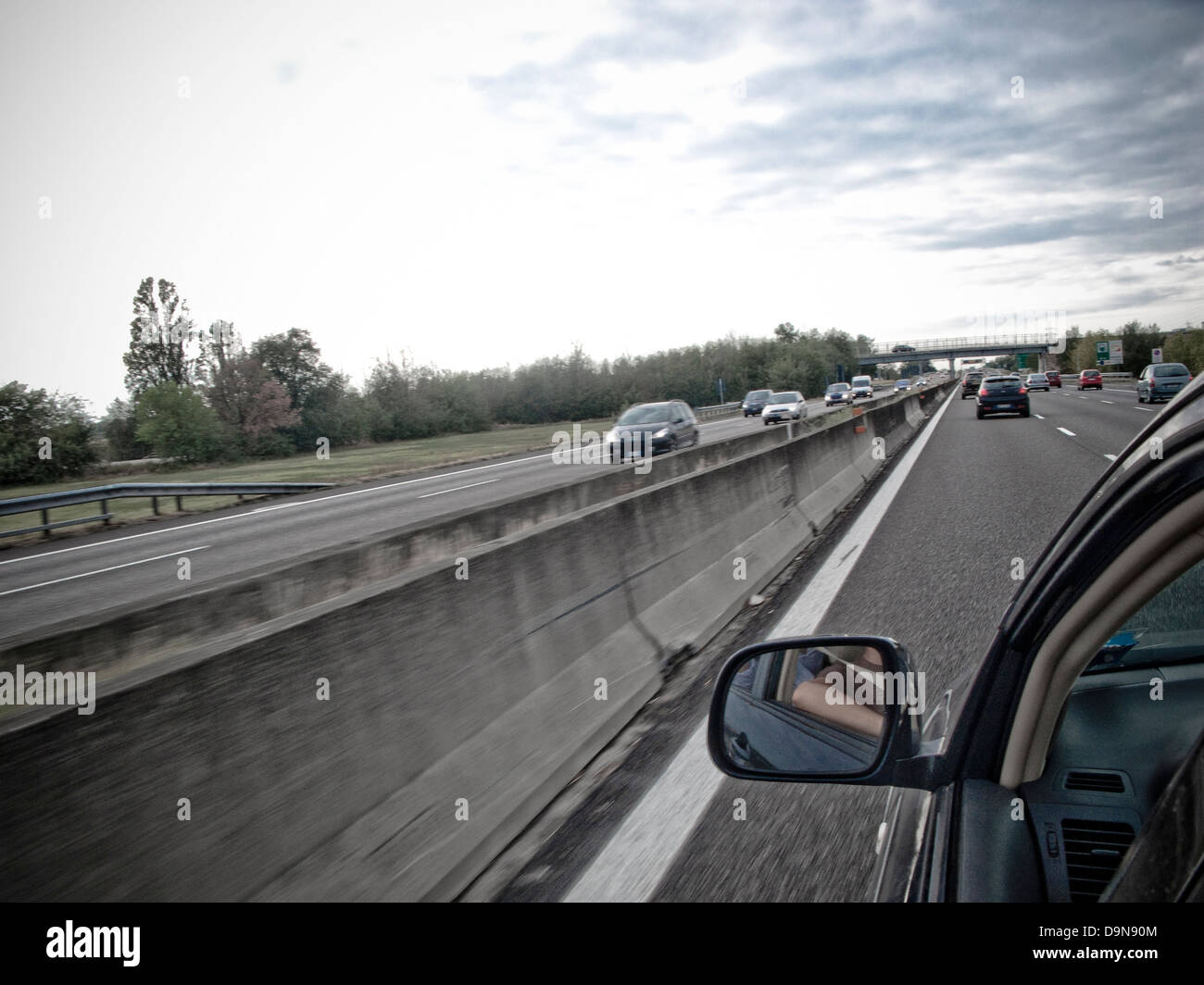 rearview mirror of a car on the highway Stock Photo