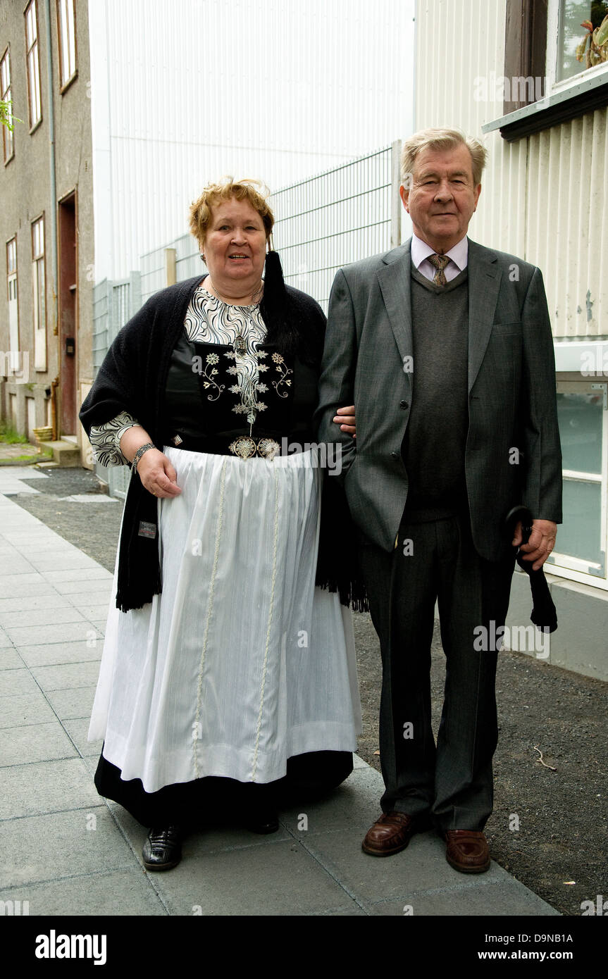 On Iceland's National Day a middleaged couple--the woman wearing full national dress--walk in a Reyjkavik street Stock Photo