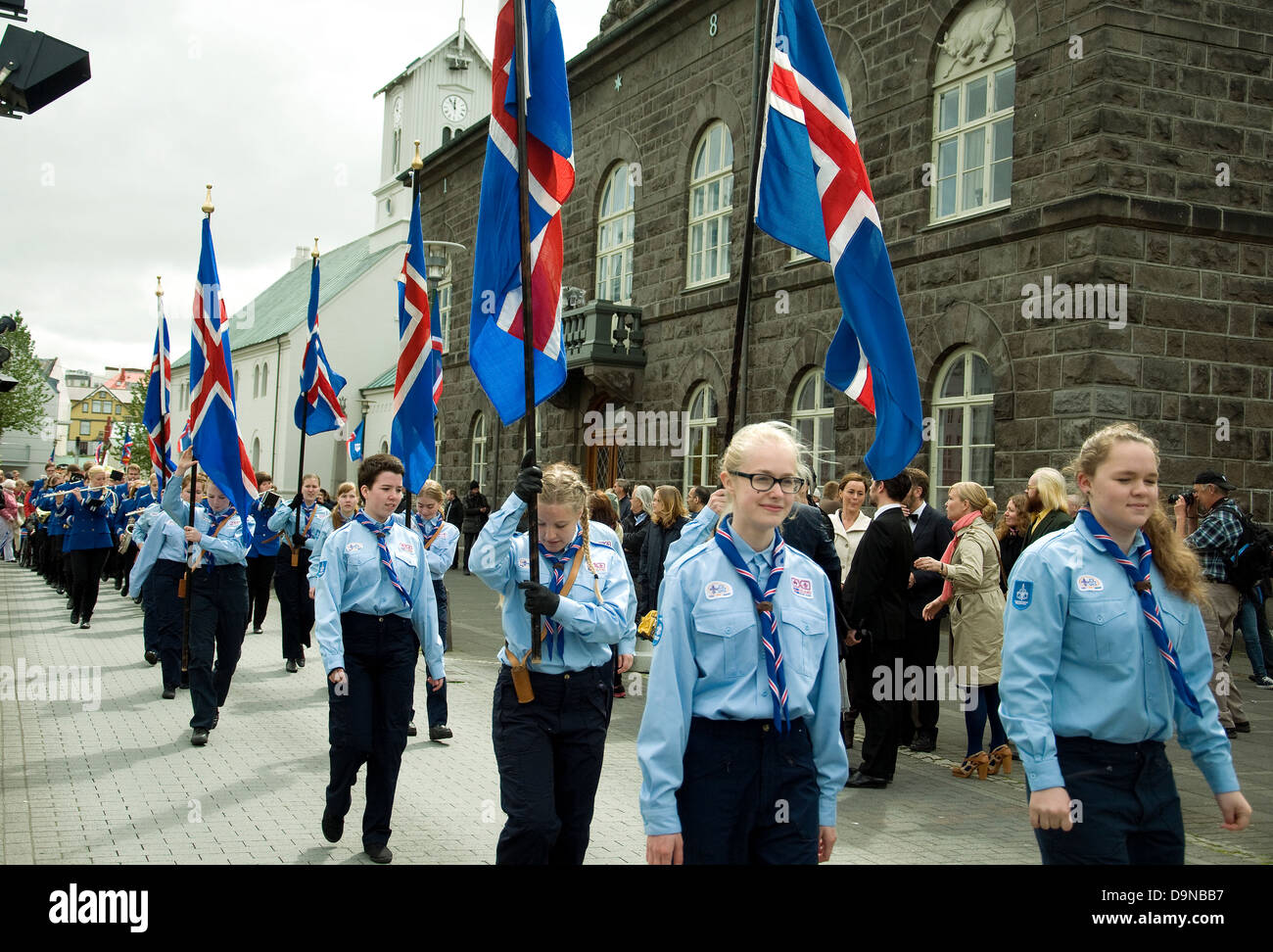 On Iceland's National Day Scouts, male and female, parade with the national flag outside Parliament, or Althing, in Reykjavik Stock Photo