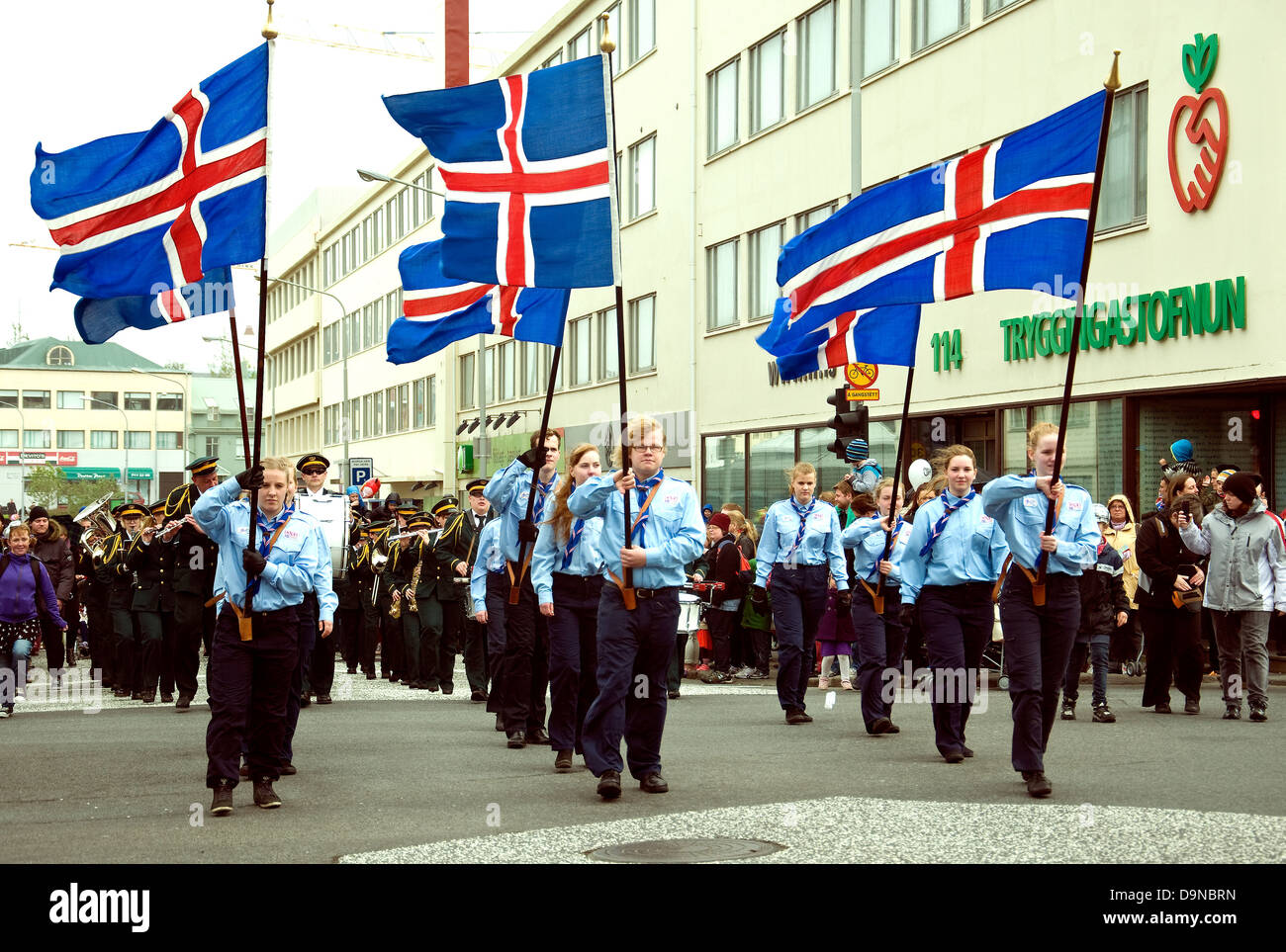 On Iceland's National Day a Scout group, male and female, marches in central Reykjavik, holding national flags Stock Photo