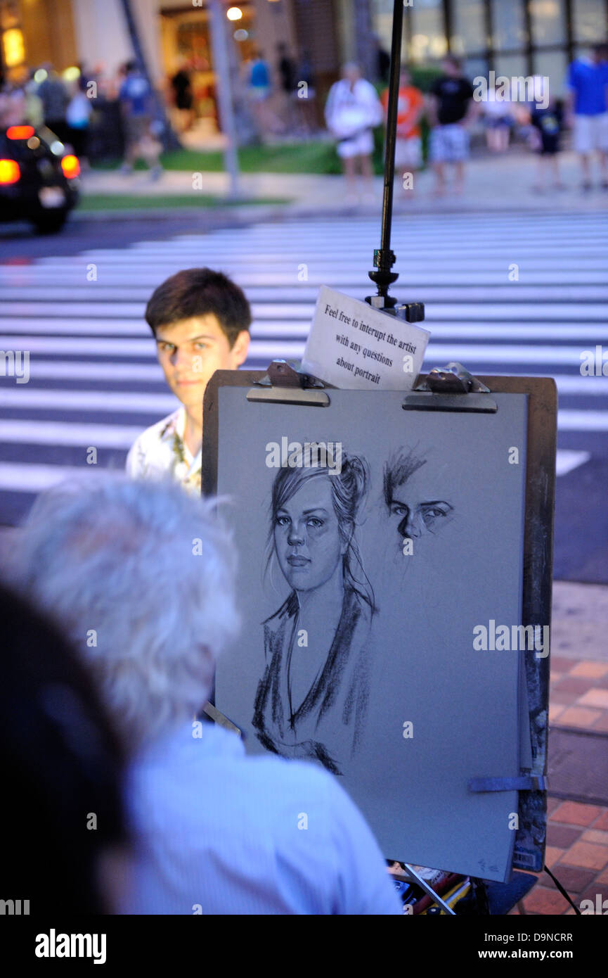 Street portrait artist with portrait in progress and model. Waikiki, Honolulu, Hawaii Stock Photo
