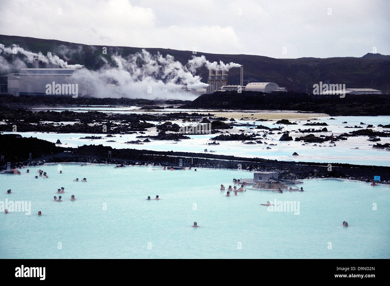Iceland's famous Blue Lagoon, popular swimming lake in the foreground, the Svartsengi geothermal energy plant at rear Stock Photo