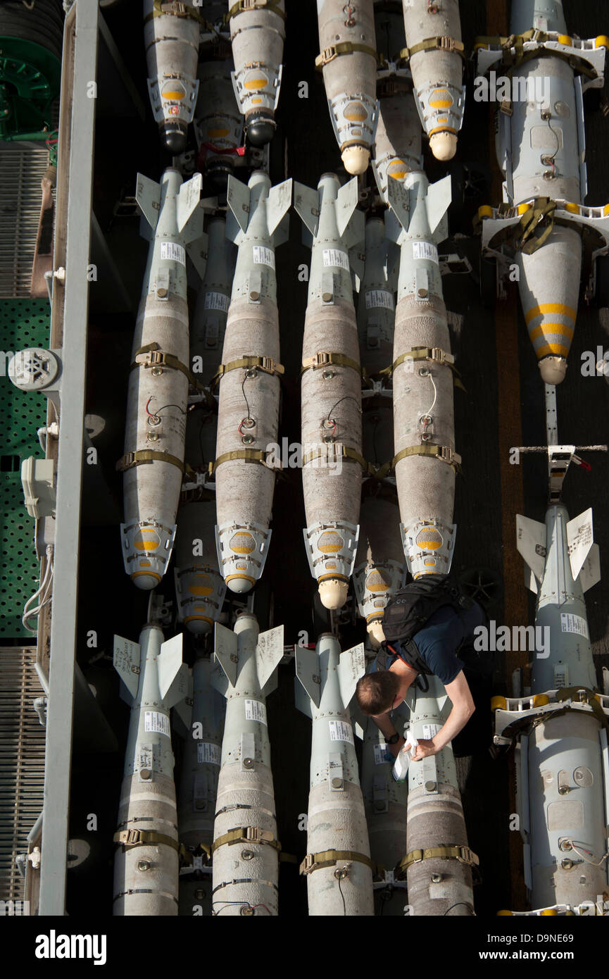 A US Navy sailor maintains and cleans ordnance aboard the aircraft carrier USS Nimitz June 22, 2013 in the Gulf of Oman. Stock Photo