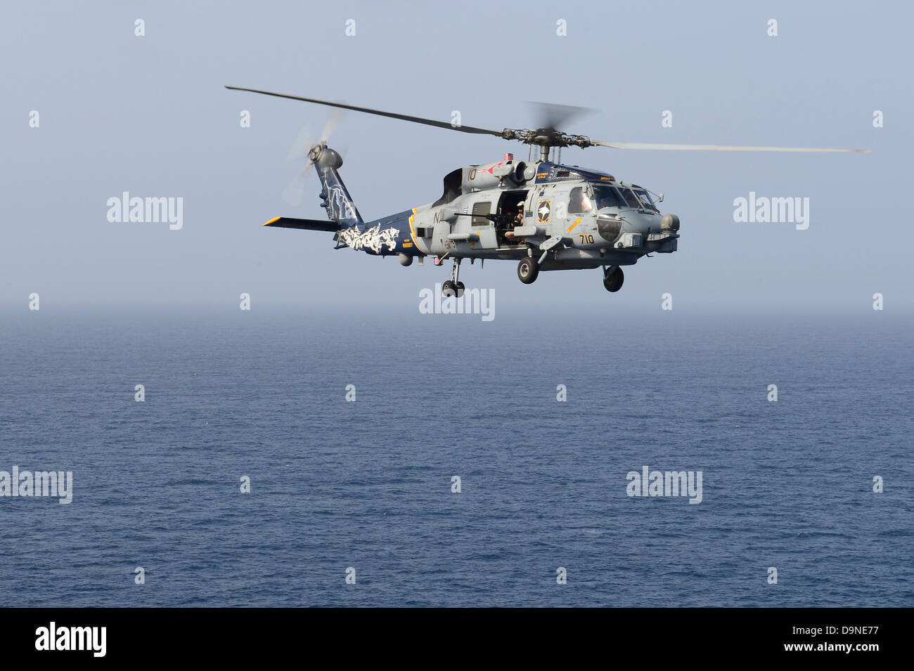 US Navy MH-60R Sea Hawk helicopters fly operating from the aircraft ...