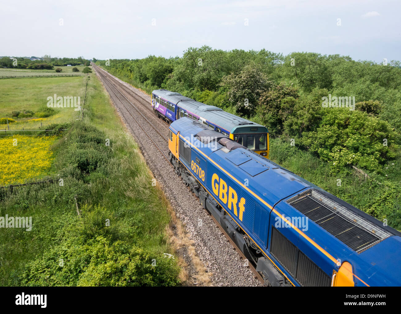 GBR Freight train and Northern Rail passenger train on Northern Rail line near Billingham, north east England, UK Stock Photo