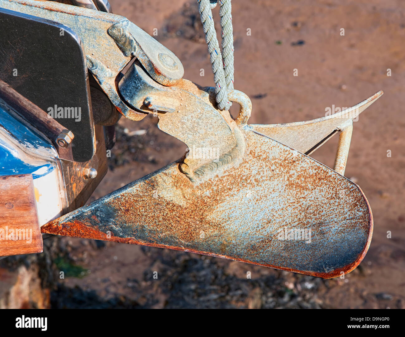 Close-up of rusty and pitted plough (CQR) anchor hanging from the bow of a boat Stock Photo