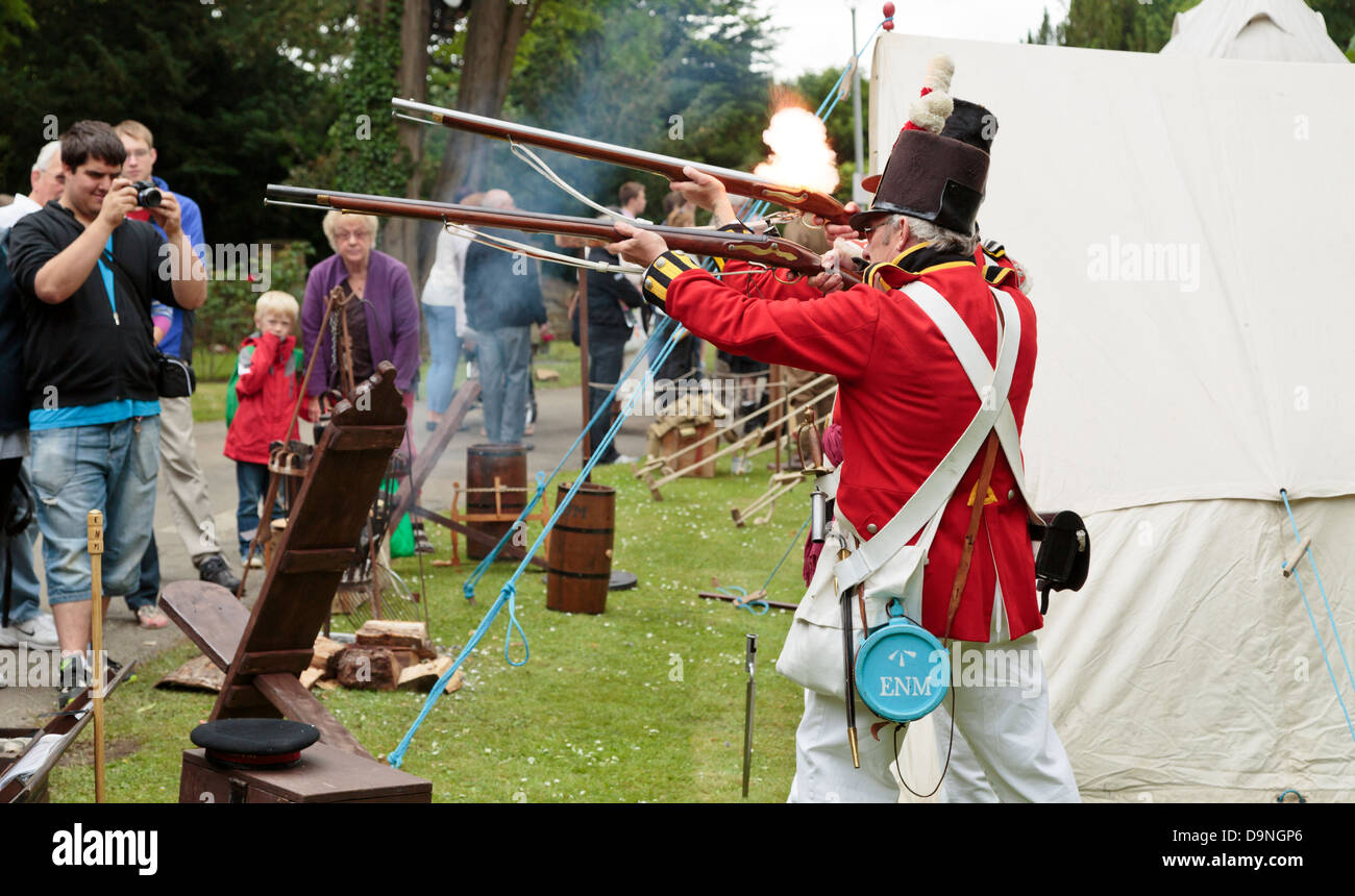 Reenactment of scene from English Civil War, soldiers firing their guns, Peterborough Heritage Festival 22 June 2013, England Stock Photo