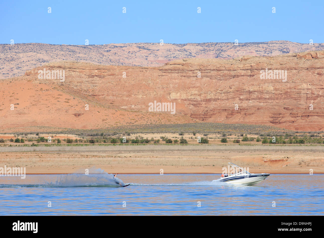 A water skier is towed behind a boat in Bullfrog Bay at Lake Powell ...