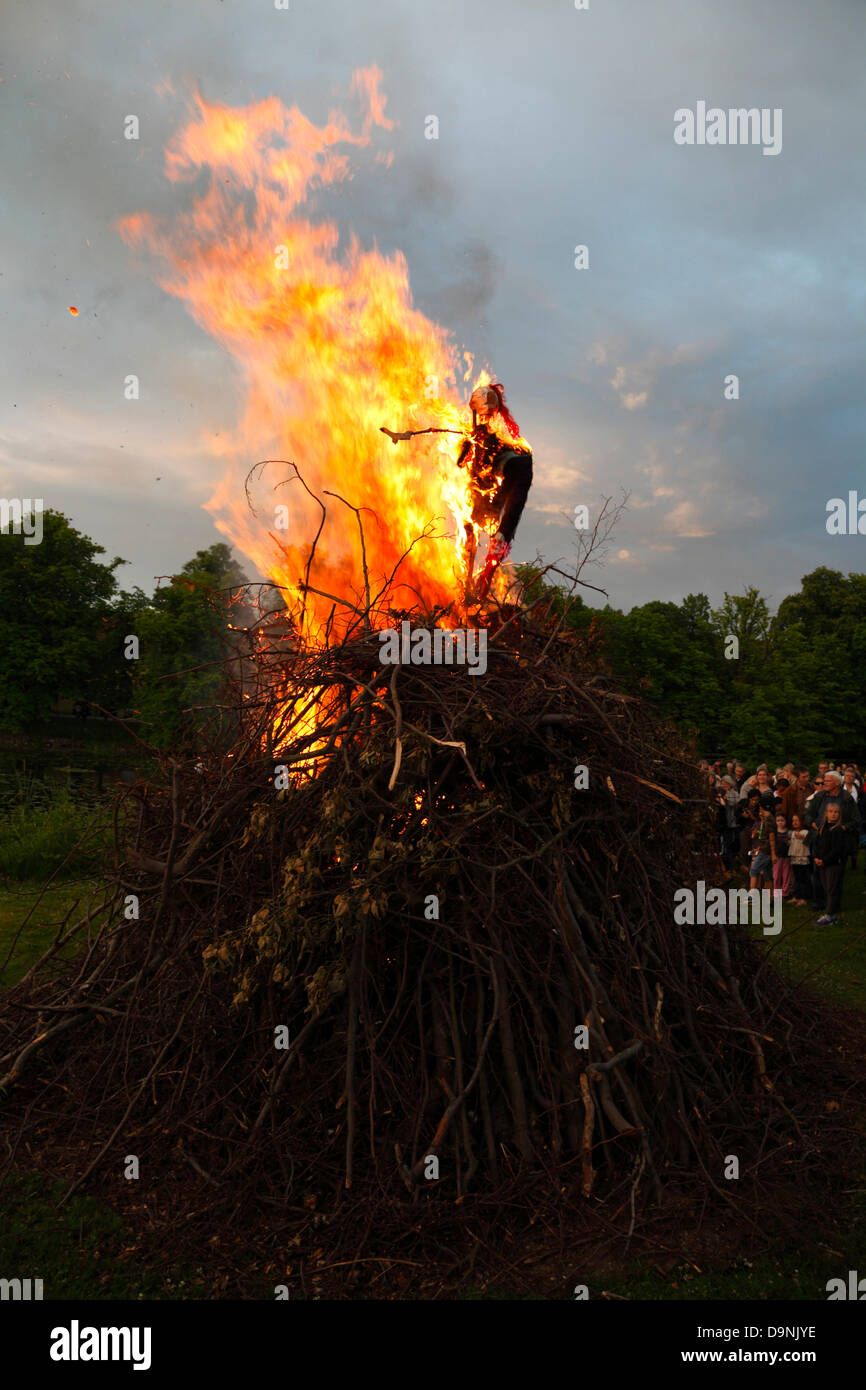 Hørsholm, north of Copenhagen, Denmark. June 23, 2013. St. John's Eve, the Midsummer Eve or Sankthansaften in Denmark is celebrated by lighting bonfires at sundown. A straw and rag witch is placed on top of the bonfire before it is lit. Then it is time for the traditional speech and midsummer song.  The bonfire arrangement including a cultural speech by a well-known person and the singing of the traditional midsummer song are held by most local authorities throughout the country. But local bonfires and celebrating parties are arranged nearly everywhere. Credit:  Niels Quist/Alamy Live News Stock Photo