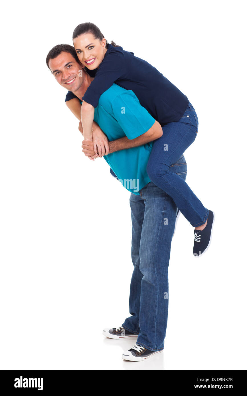 beautiful young girl piggybacking on her boyfriend over white background Stock Photo