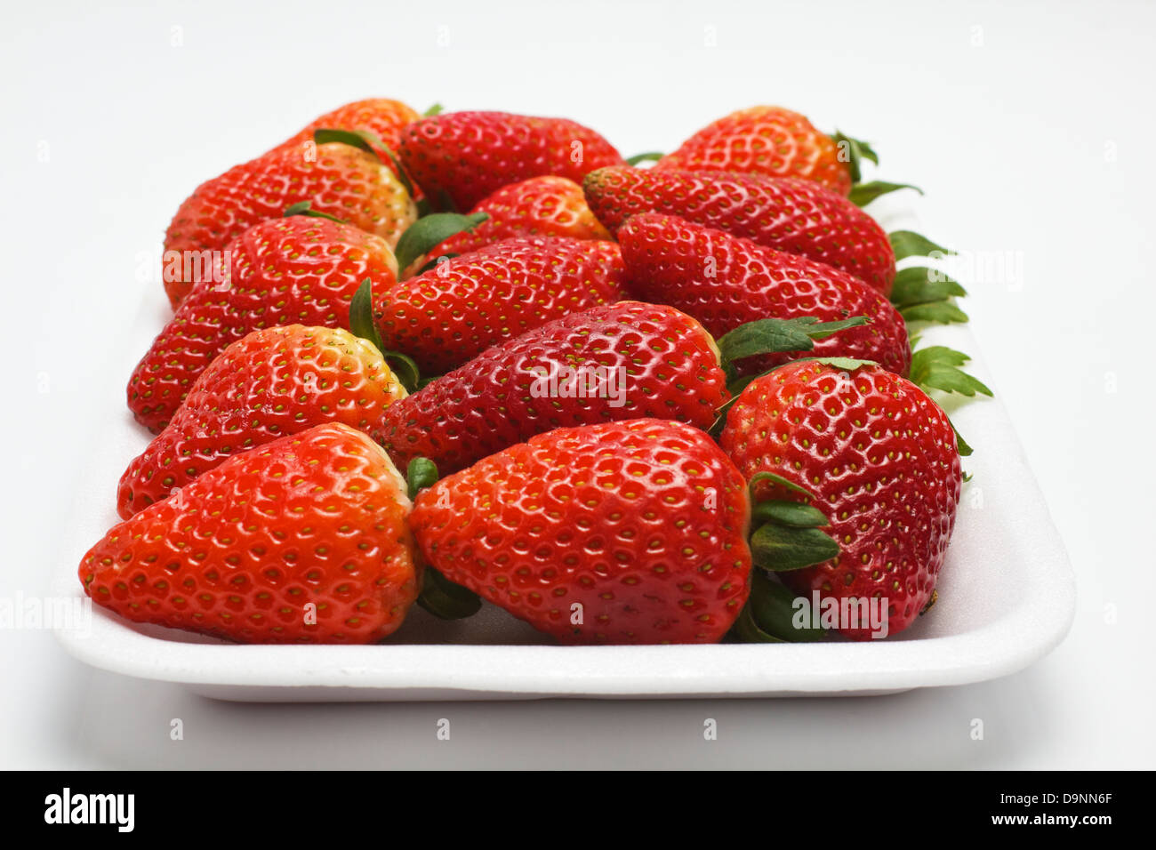 A plate with a lot of strawberries isolated on a white background Stock ...