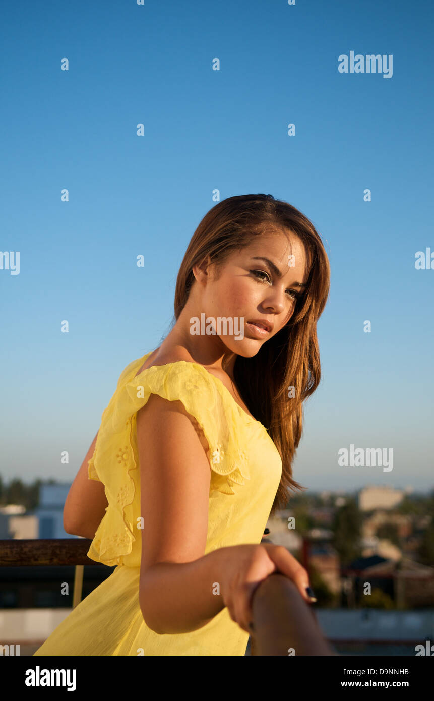Portrait of beautiful multiracial model in yellow dress. Stock Photo