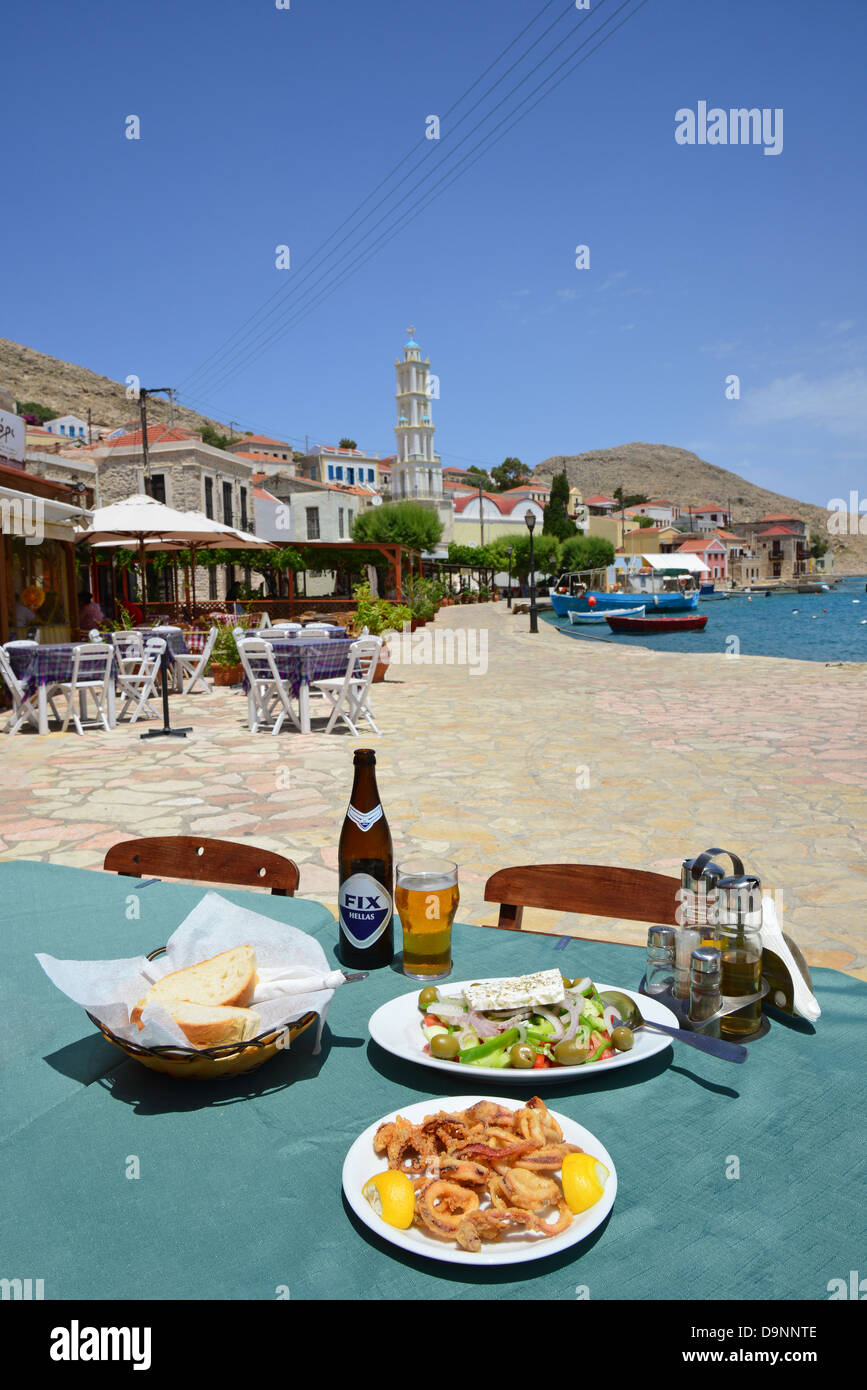 Greek meal at waterfront taverna, Port of Emporio, Halki (Chalki), Rhodes (Rodos) Region, Dodecanese, South Aegean, Greece Stock Photo