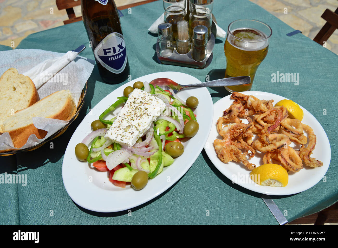 Greek meal at waterfront taverna, Port of Emporio, Halki (Chalki), Rhodes (Rodos) Region, Dodecanese, South Aegean, Greece Stock Photo