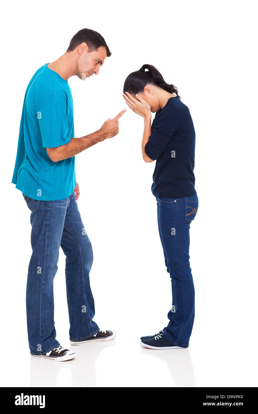 angry man pointing his crying girlfriend isolated on white background Stock Photo