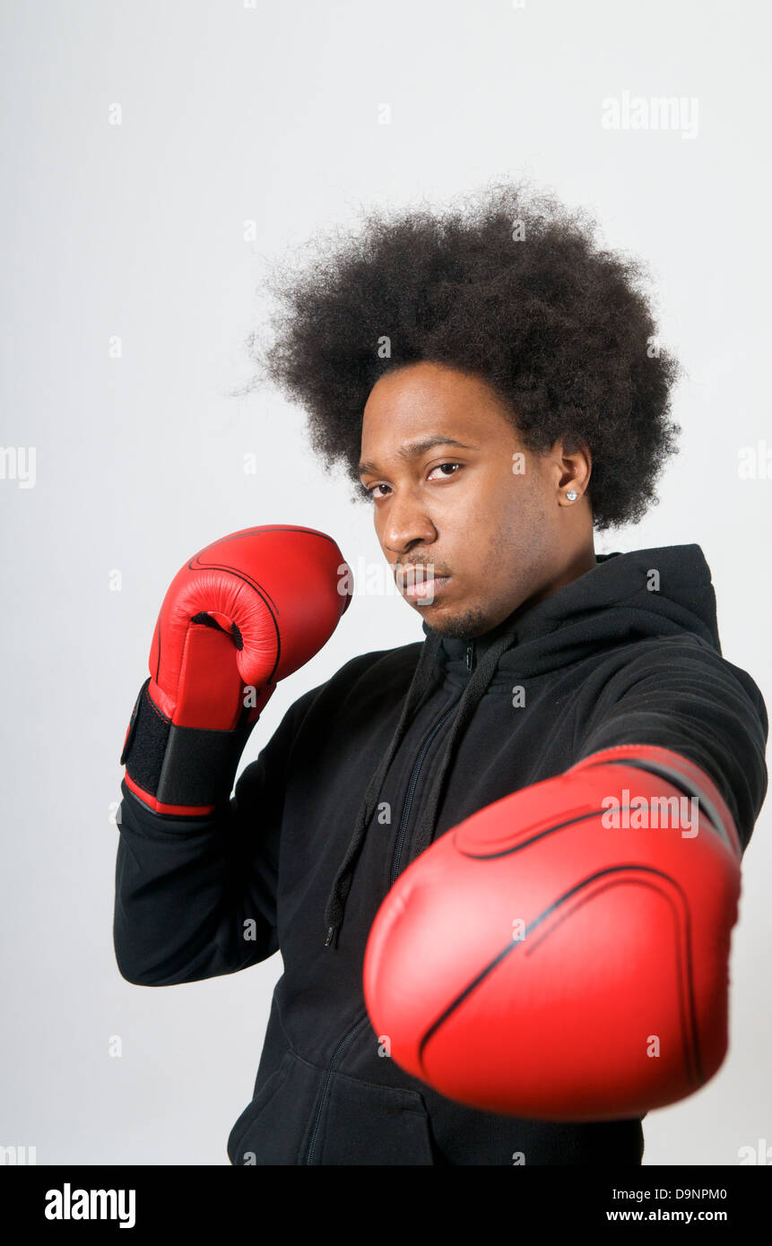 Black Boxer with red boxing gloves in defence Stock Photo Alamy