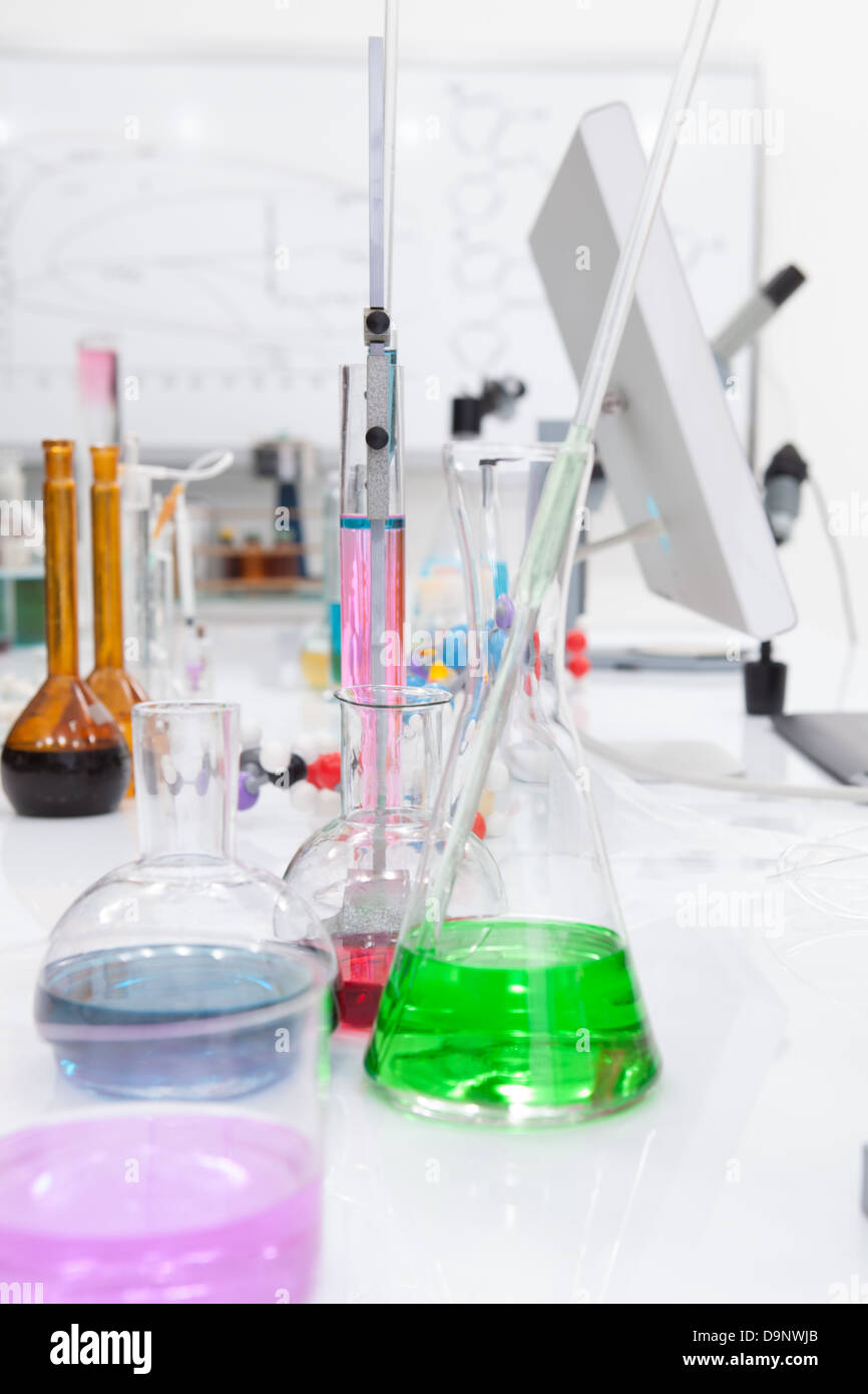 close up of laboratory tools and colorful liquids on a lab table laboratory tools