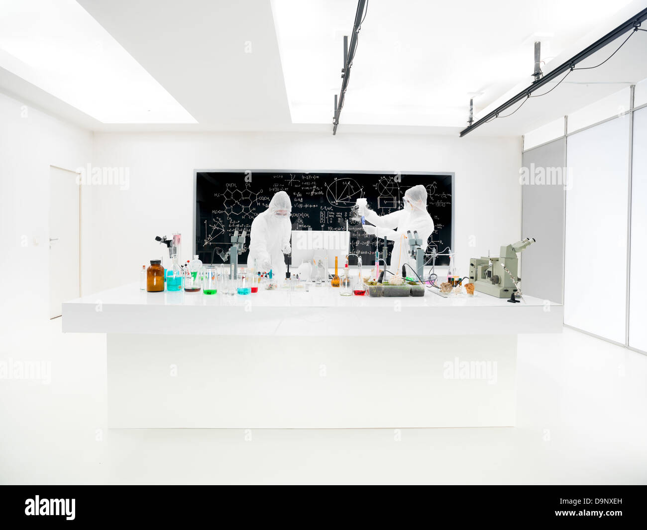 closeup of two scientists in a chemistry lab conducting an experiment